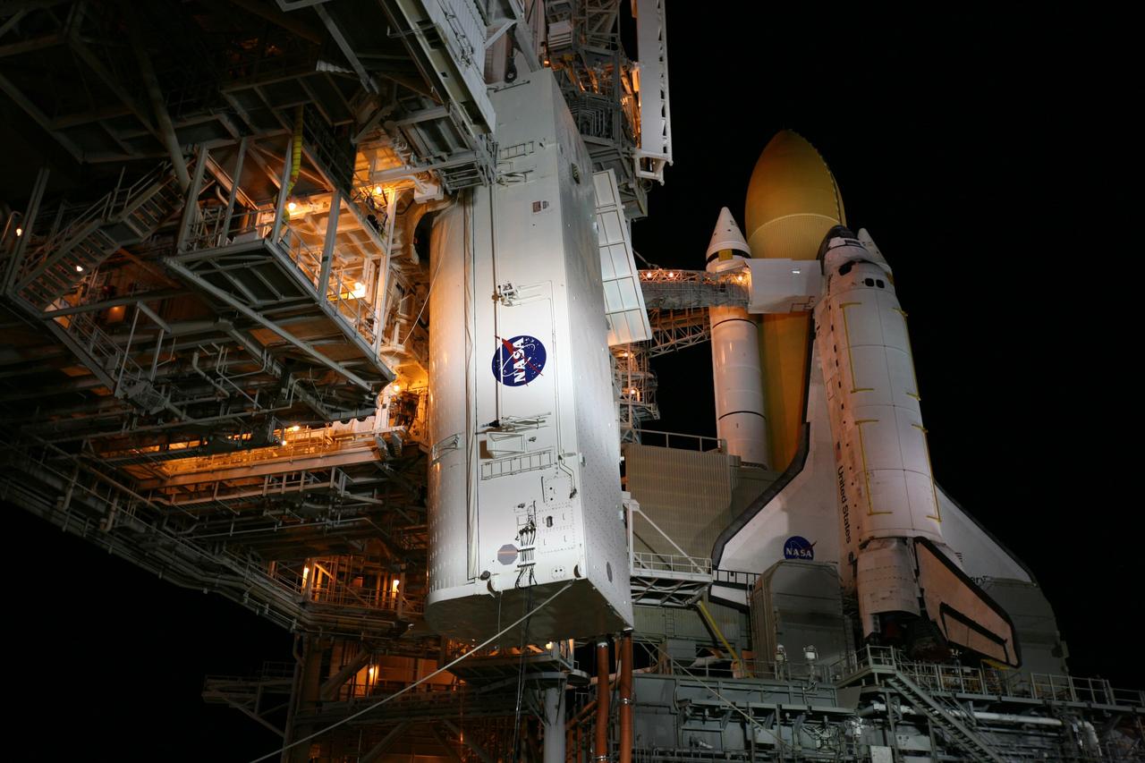 CAPE CANAVERAL, Fla. -- At NASA's Kennedy Space Center in Florida, the STS-133 payload canister is lifted into the rotating service structure on Launch Pad 39A.        The payload then will be moved into space shuttle Discovery's payload bay. Discovery and its STS-133 crew will deliver the Permanent Multipurpose Module, packed with supplies and critical spare parts, as well as Robonaut 2, the dexterous humanoid astronaut helper, to the International Space Station. Launch is targeted for 4:40 p.m. EDT, Nov. 1. Photo credit: NASA/Amanda Diller