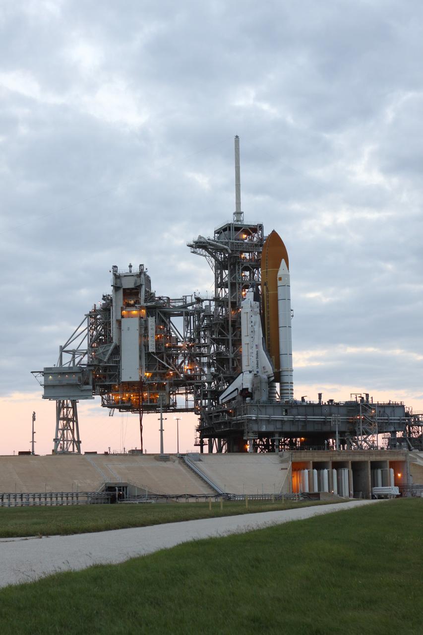 CAPE CANAVERAL, Fla. -- As dawn approaches at NASA's Kennedy Space Center in Florida, the STS-133 payload canister now is in the rotating service structure on Launch Pad 39A.      The payload then will be moved into space shuttle Discovery's payload bay. Discovery and its STS-133 crew will deliver the Permanent Multipurpose Module, packed with supplies and critical spare parts, as well as Robonaut 2, the dexterous humanoid astronaut helper, to the International Space Station. Launch is targeted for 4:40 p.m. EDT, Nov. 1. Photo credit: NASA/Troy Cryder