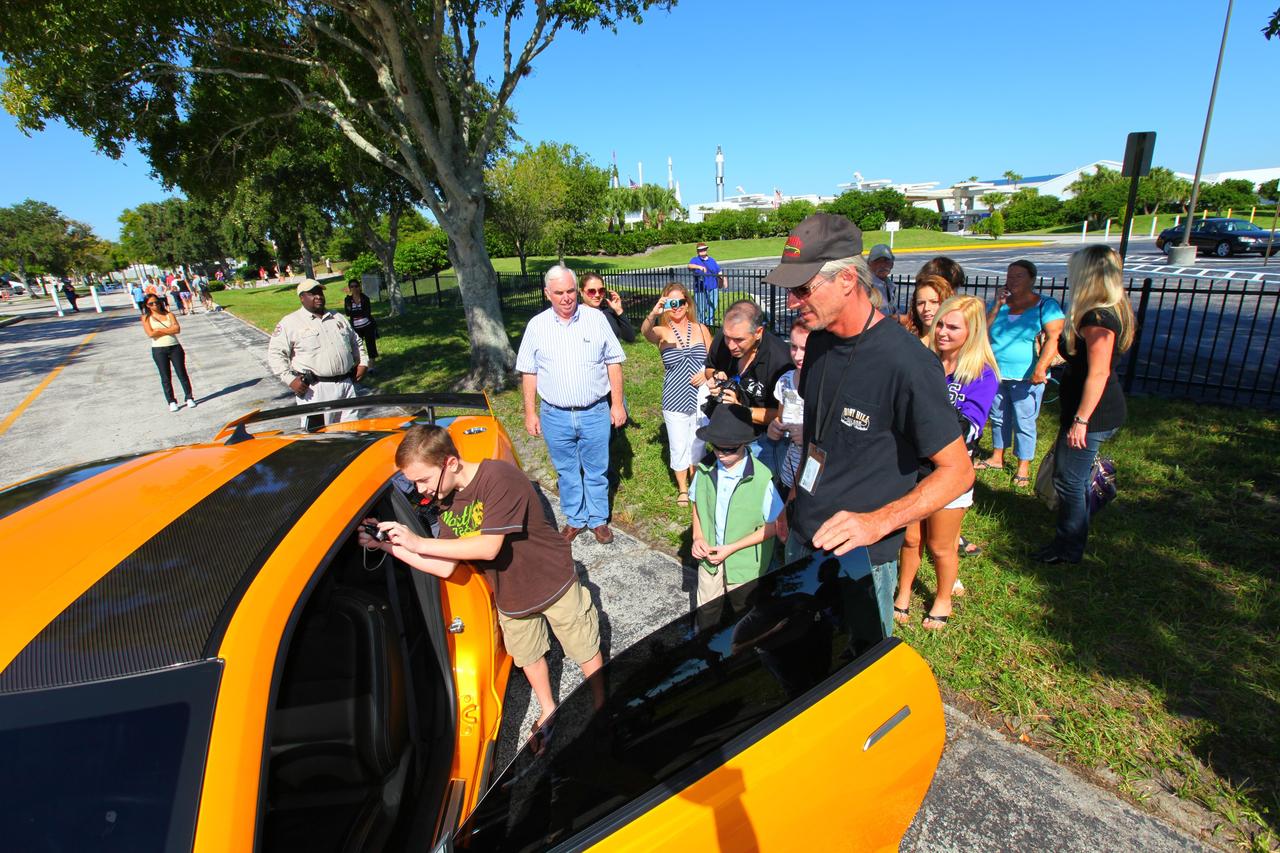 CAPE CANAVERAL, Fla. -- NASA Kennedy Space Center employees in Florida were provided a unique photo opportunity on Oct. 8 from some of the robot 'stars' of the upcoming movie, "Transformers 3." Paramount Pictures filmed scenes for the movie at Kennedy from Oct. 4 through 8. As a show of appreciation for sharing the space center with the "Transformers 3" cast and crew, Kennedy employees and their families were invited to see two Transformers characters, Optimus Prime and Bumblebee, in their vehicle form, on display outside Kennedy Space Center Visitor Complex. In this image Kennedy employee family members are able to peer inside of 'Bumblebee's' interior. "Transformers 3" is due out in theaters summer 2011. Photo credit: NASA/Frank Michaux