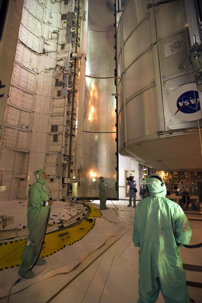 CAPE CANAVERAL, Fla. -- At NASA's Kennedy Space Center in Florida, technicians prepare to move the STS-133 payload from the rotating service structure on Launch Pad 39A to space shuttle Discovery's payload bay. The move paves the way for the Terminal Countdown Demonstration Test (TCDT) this week, which will give the astronauts and teams at Kennedy and NASA's Johnson Space Center in Houston a chance to practice launch day tasks.     Discovery and its STS-133 crew will deliver the Permanent Multipurpose Module, packed with supplies and critical spare parts, as well as Robonaut 2, the dexterous humanoid astronaut helper, to the International Space Station. Launch is targeted for 4:40 p.m. EDT, Nov. 1. Photo credit: NASA/Dimitri Gerondidakis