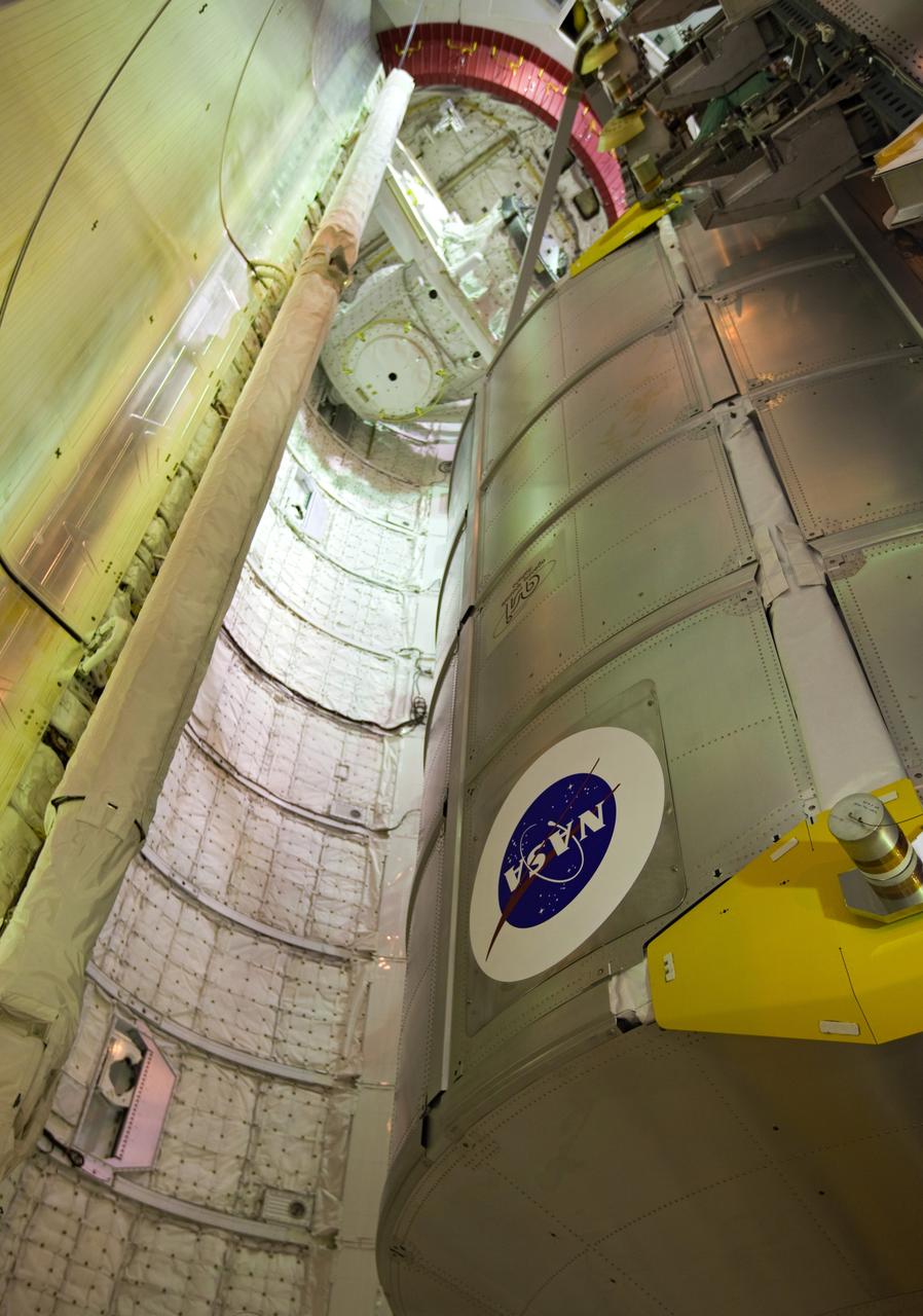 CAPE CANAVERAL, Fla. -- At NASA's Kennedy Space Center in Florida, technicians prepare to move the STS-133 payload from the rotating service structure on Launch Pad 39A to space shuttle Discovery's payload bay. The move paves the way for the Terminal Countdown Demonstration Test (TCDT) this week, which will give the astronauts and teams at Kennedy and NASA's Johnson Space Center in Houston a chance to practice launch day tasks.     Discovery and its STS-133 crew will deliver the Permanent Multipurpose Module, packed with supplies and critical spare parts, as well as Robonaut 2, the dexterous humanoid astronaut helper, to the International Space Station. Launch is targeted for 4:40 p.m. EDT, Nov. 1. Photo credit: NASA/Dimitri Gerondidakis
