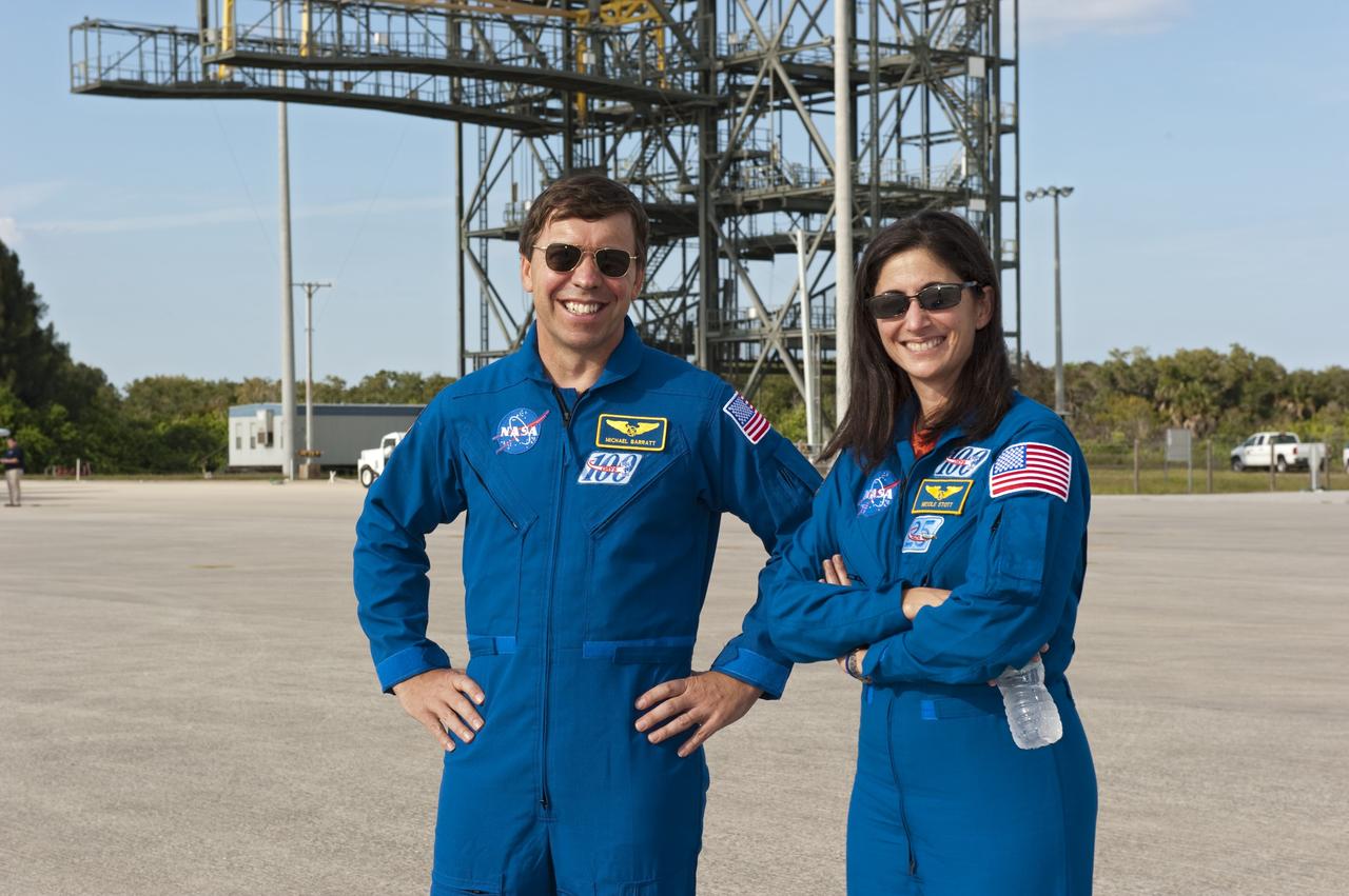CAPE CANAVERAL, Fla. -- At NASA's Kennedy Space Center in Florida, STS-133 Mission Specialists Michael Barratt and Nicole Stott pause for a photo after arrival in T-38 training jets to the Shuttle Landing Facility. The STS-133 crew is at Kennedy for a practice launch dress rehearsal called the Terminal Countdown Demonstration Test (TCDT) in preparation for their upcoming mission.         TCDT provides each shuttle crew and launch team with an opportunity to participate in various simulated countdown activities, including equipment familiarization and emergency training. Space shuttle Discovery and its STS-133 crew will deliver the Permanent Multipurpose Module, packed with supplies and critical spare parts, as well as Robonaut 2, the dexterous humanoid astronaut helper, to the International Space Station. Launch is targeted for Nov. 1 at 4:40 p.m. For more information on the STS-133 mission, visit www.nasa.gov/shuttle. Photo credit: NASA/Kim Shiflett