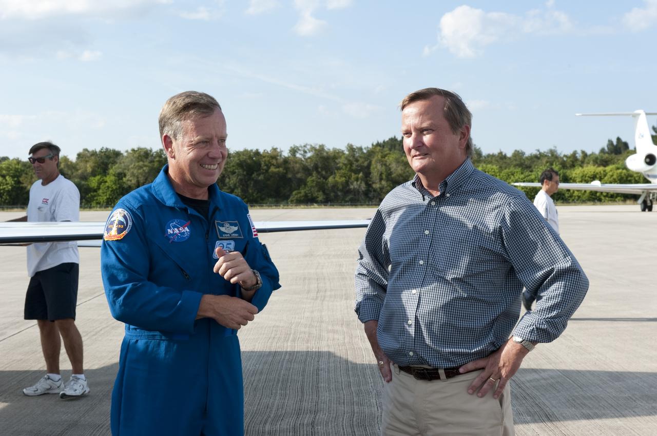 CAPE CANAVERAL, Fla. -- At NASA's Kennedy Space Center in Florida, STS-133 Commander Steve Lindsey talks with Shuttle Launch Director Mike Leinbach at the Shuttle Landing Facility. The STS-133 crew members are at Kennedy for a practice launch dress rehearsal called the Terminal Countdown Demonstration Test (TCDT) in preparation for their upcoming mission.      TCDT provides each shuttle crew and launch team with an opportunity to participate in various simulated countdown activities, including equipment familiarization and emergency training. Space shuttle Discovery and its STS-133 crew will deliver the Permanent Multipurpose Module, packed with supplies and critical spare parts, as well as Robonaut 2, the dexterous humanoid astronaut helper, to the International Space Station. Launch is targeted for Nov. 1 at 4:40 p.m. For more information on the STS-133 mission, visit www.nasa.gov/shuttle. Photo credit: NASA/Kim Shiflett