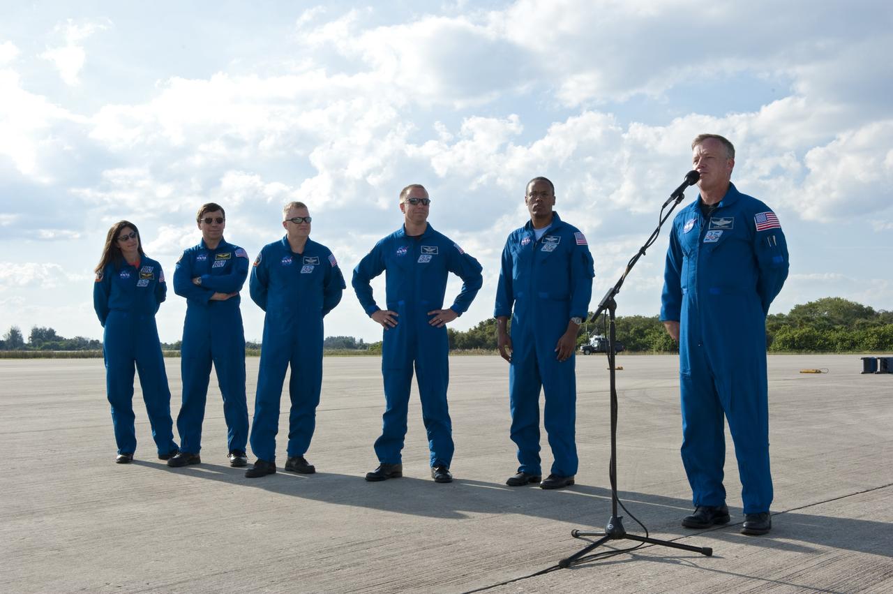 CAPE CANAVERAL, Fla. -- At NASA's Kennedy Space Center in Florida, STS-133 Commander Steve Lindsey speaks to the media gathered for his crew’s arrival at the Shuttle Landing Facility. From left are Mission Specialists Nicole Stott, Michael Barratt; Pilot Eric Boe and Mission Specialists Tim Kopra and Alvin Drew. The STS-133 crew members are at Kennedy for a practice launch dress rehearsal called the Terminal Countdown Demonstration Test (TCDT) in preparation for their upcoming mission.      TCDT provides each shuttle crew and launch team with an opportunity to participate in various simulated countdown activities, including equipment familiarization and emergency training. Space shuttle Discovery and its STS-133 crew will deliver the Permanent Multipurpose Module, packed with supplies and critical spare parts, as well as Robonaut 2, the dexterous humanoid astronaut helper, to the International Space Station. Launch is targeted for Nov. 1 at 4:40 p.m. For more information on the STS-133 mission, visit www.nasa.gov/shuttle. Photo credit: NASA/Kim Shiflett