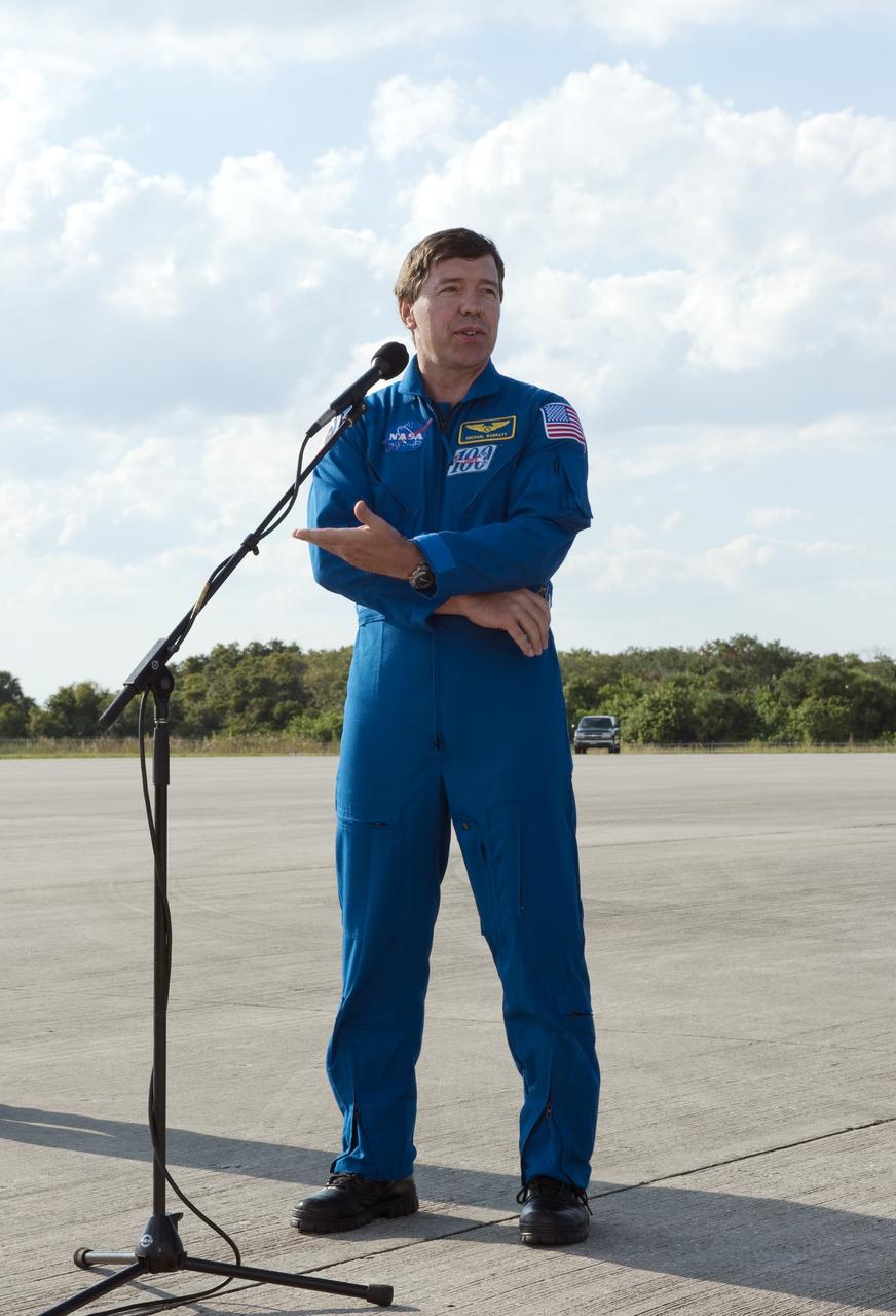 CAPE CANAVERAL, Fla. -- At NASA's Kennedy Space Center in Florida, STS-133 Mission Specialist Michael Barratt speaks to the media gathered for the crew’s arrival at the Shuttle Landing Facility. The STS-133 crew members are at Kennedy for a practice launch dress rehearsal called the Terminal Countdown Demonstration Test (TCDT) in preparation for their upcoming mission.      TCDT provides each shuttle crew and launch team with an opportunity to participate in various simulated countdown activities, including equipment familiarization and emergency training. Space shuttle Discovery and its STS-133 crew will deliver the Permanent Multipurpose Module, packed with supplies and critical spare parts, as well as Robonaut 2, the dexterous humanoid astronaut helper, to the International Space Station. Launch is targeted for Nov. 1 at 4:40 p.m. For more information on the STS-133 mission, visit www.nasa.gov/shuttle. Photo credit: NASA/Kim Shiflett