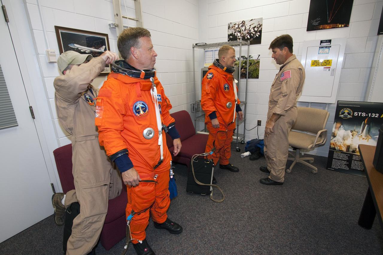 CAPE CANAVERAL, Fla. -- At NASA's Kennedy Space Center in Florida, STS-133 Commander Steve Lindsey and Pilot Eric Boe put on their orange flight suits in the Shuttle Landing Facility's Landing Aids Control Building, which is on the south end of the facility's runway. They are preparing to practice landings in Shuttle Training Aircraft, modified Gulfstream II business jets that mimic the shuttle's handling during the final phase of landing. Practice landings are part of the Terminal Countdown Demonstration Test (TCDT), which provides each shuttle crew and launch team an opportunity to participate in various simulated activities, including equipment familiarization and emergency training at the launch pad.    Space shuttle Discovery and its STS-133 crew will deliver the Permanent Multipurpose Module, packed with supplies and critical spare parts, as well as Robonaut 2, the dexterous humanoid astronaut helper, to the International Space Station. Launch is targeted for Nov. 1 at 4:40 p.m. For more information on the STS-133 mission, visit www.nasa.gov/mission_pages/shuttle/shuttlemissions/sts133/. Photo credit: NASA/Jack Pfaller