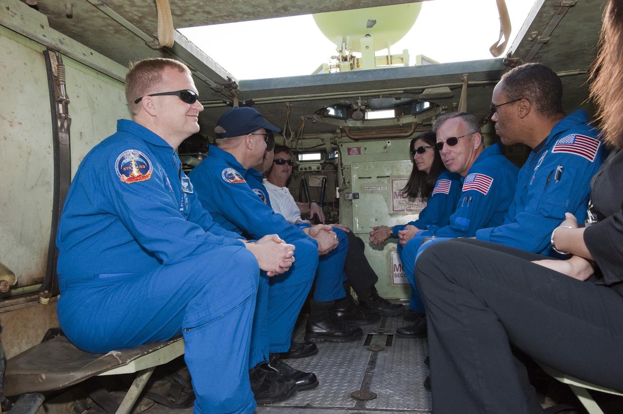 CAPE CANAVERAL, Fla. -- At NASA's Kennedy Space Center in Florida, the crew members of space shuttle Discovery's STS-133 mission experience the interior of an M-113 armored personnel carrier. From left are Pilot Eric Boe, Mission Specialists Tim Kopra and Michael Barratt, Battalion Chief David Seymour, Mission Specialist Nicole Stott, Commander Steve Lindsey and Mission Specialist Alvin Drew. An M-113 is kept at the foot of the launch pad in case an emergency egress from the vicinity of the pad is needed, and training on the vehicle is part of the Terminal Countdown Demonstration Test (TCDT). TCDT provides each shuttle crew and launch team an opportunity to participate in various simulated activities, including equipment familiarization and a launch countdown.    Space shuttle Discovery and its STS-133 crew will deliver the Permanent Multipurpose Module, packed with supplies and critical spare parts, as well as Robonaut 2, the dexterous humanoid astronaut helper, to the International Space Station. Launch is targeted for Nov. 1 at 4:40 p.m. For more information on the STS-133 mission, visit www.nasa.gov/mission_pages/shuttle/shuttlemissions/sts133/. Photo credit: NASA/Kim Shiflett