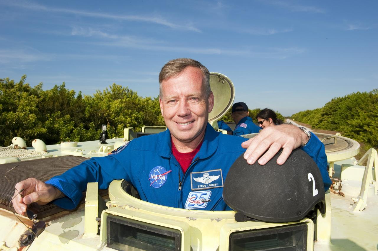 CAPE CANAVERAL, Fla. -- At NASA's Kennedy Space Center in Florida, STS-133 Commander Steve Lindsey prepares to practice driving an M-113 armored personnel carrier. Behind him are Mission Specialist Tim Kopra and Pilot Eric Boe. An M-113 is kept at the foot of the launch pad in case an emergency egress from the vicinity of the pad is needed, and training on the vehicle is part of the Terminal Countdown Demonstration Test (TCDT). TCDT provides each shuttle crew and launch team an opportunity to participate in various simulated activities, including equipment familiarization and a launch countdown.    Space shuttle Discovery and its STS-133 crew will deliver the Permanent Multipurpose Module, packed with supplies and critical spare parts, as well as Robonaut 2, the dexterous humanoid astronaut helper, to the International Space Station. Launch is targeted for Nov. 1 at 4:40 p.m. For more information on the STS-133 mission, visit www.nasa.gov/mission_pages/shuttle/shuttlemissions/sts133/. Photo credit: NASA/Kim Shiflett