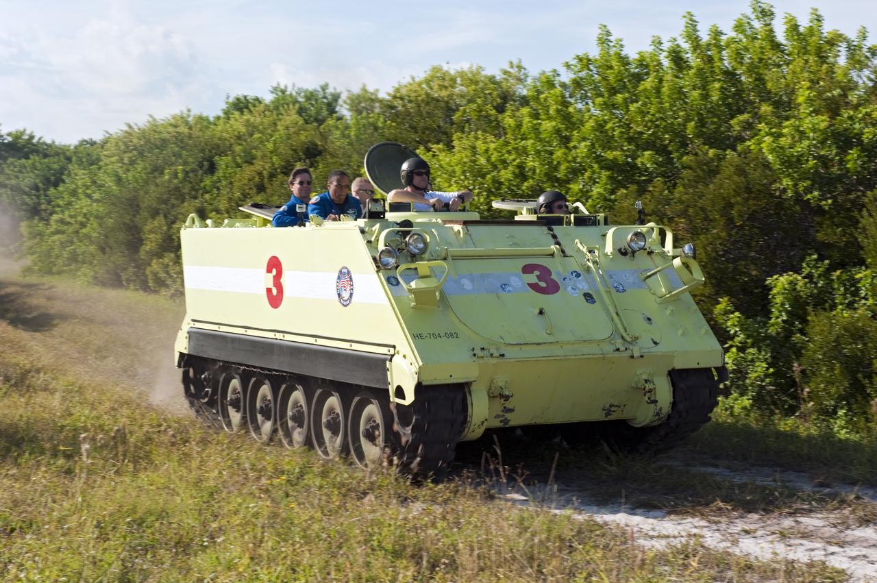 CAPE CANAVERAL, Fla. -- At NASA's Kennedy Space Center in Florida, the crew members of space shuttle Discovery's STS-133 mission go for a ride in an M-113 armored personnel carrier with Battalion Chief David Seymour. An M-113 is kept at the foot of the launch pad in case an emergency egress from the vicinity of the pad is needed, and training on the vehicle is part of the Terminal Countdown Demonstration Test (TCDT). TCDT provides each shuttle crew and launch team an opportunity to participate in various simulated activities, including equipment familiarization and a launch countdown.    Space shuttle Discovery and its STS-133 crew will deliver the Permanent Multipurpose Module, packed with supplies and critical spare parts, as well as Robonaut 2, the dexterous humanoid astronaut helper, to the International Space Station. Launch is targeted for Nov. 1 at 4:40 p.m. For more information on the STS-133 mission, visit www.nasa.gov/mission_pages/shuttle/shuttlemissions/sts133/. Photo credit: NASA/Kim Shiflett