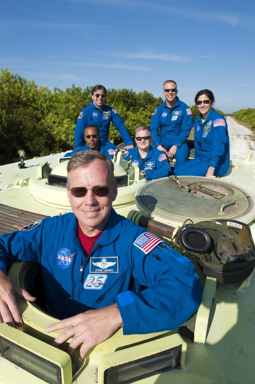 CAPE CANAVERAL, Fla. -- At NASA's Kennedy Space Center in Florida, STS-133 Commander Steve Lindsey prepares to practice driving an M-113 armored personnel carrier. Behind him, from left are Mission Specialists Michael Barratt and Alvin Drew, Pilot Eric Boe, and Mission Specialists Tim Kopra and Nicole Stott. An M-113 is kept at the foot of the launch pad in case an emergency egress from the vicinity of the pad is needed, and training on the vehicle is part of the Terminal Countdown Demonstration Test (TCDT). TCDT provides each shuttle crew and launch team an opportunity to participate in various simulated activities, including equipment familiarization and a launch countdown.    Space shuttle Discovery and its STS-133 crew will deliver the Permanent Multipurpose Module, packed with supplies and critical spare parts, as well as Robonaut 2, the dexterous humanoid astronaut helper, to the International Space Station. Launch is targeted for Nov. 1 at 4:40 p.m. For more information on the STS-133 mission, visit www.nasa.gov/mission_pages/shuttle/shuttlemissions/sts133/. Photo credit: NASA/Kim Shiflett