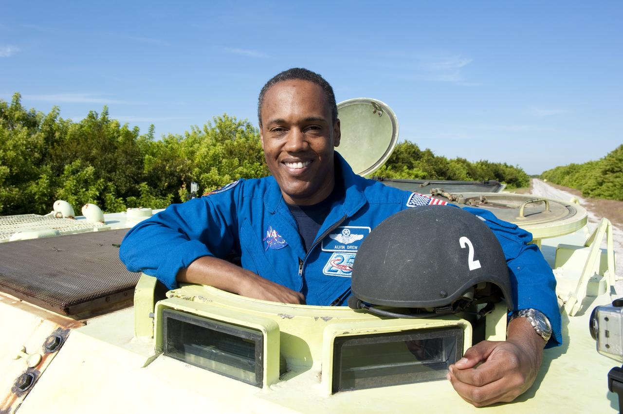 CAPE CANAVERAL, Fla. -- At NASA's Kennedy Space Center in Florida, STS-133 Mission Specialist Alvin Drew prepares to practice driving an M-113 armored personnel carrier. Behind him is Commander Steve Lindsey. An M-113 is kept at the foot of the launch pad in case an emergency egress from the vicinity of the pad is needed, and training on the vehicle is part of the Terminal Countdown Demonstration Test (TCDT). TCDT provides each shuttle crew and launch team an opportunity to participate in various simulated activities, including equipment familiarization and a launch countdown.    Space shuttle Discovery and its STS-133 crew will deliver the Permanent Multipurpose Module, packed with supplies and critical spare parts, as well as Robonaut 2, the dexterous humanoid astronaut helper, to the International Space Station. Launch is targeted for Nov. 1 at 4:40 p.m. For more information on the STS-133 mission, visit www.nasa.gov/mission_pages/shuttle/shuttlemissions/sts133/. Photo credit: NASA/Kim Shiflett