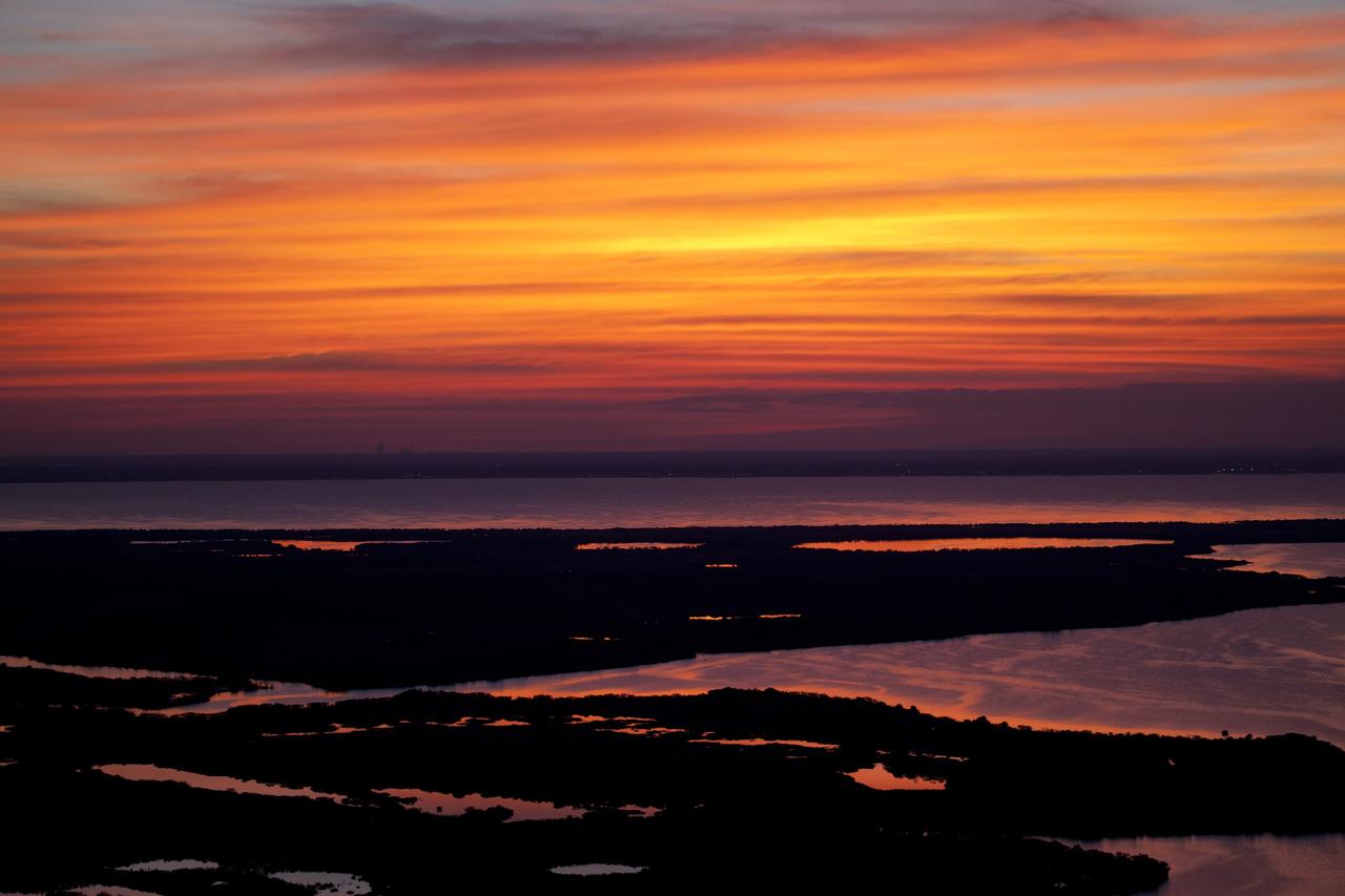 CAPE CANAVERAL, Fla. -- While performing touch-and-go landings over the Shuttle Landing Facility runway, STS-133 Commander Steve Lindsey and Pilot Eric Boe enjoyed a perfect sunset over NASA's Kennedy Space Center in Florida. Lindsey and Boe flew two Shuttle Training Aircraft (STA), which are Gulfstream II business jets modified to mimic the shuttle's handling during the final phase of landing. Practice landings are part of the Terminal Countdown Demonstration Test (TCDT), which provides each shuttle crew and launch team an opportunity to participate in various simulated activities, including equipment familiarization and emergency training at the launch pad.        Space shuttle Discovery and its STS-133 crew will deliver the Permanent Multipurpose Module, packed with supplies and critical spare parts, as well as Robonaut 2, the dexterous humanoid astronaut helper, to the International Space Station. Launch is targeted for Nov. 1 at 4:40 p.m. For more information on the STS-133 mission, visit www.nasa.gov/mission_pages/shuttle/shuttlemissions/sts133/. Photo credit: NASA/Dimitri Gerondidakis