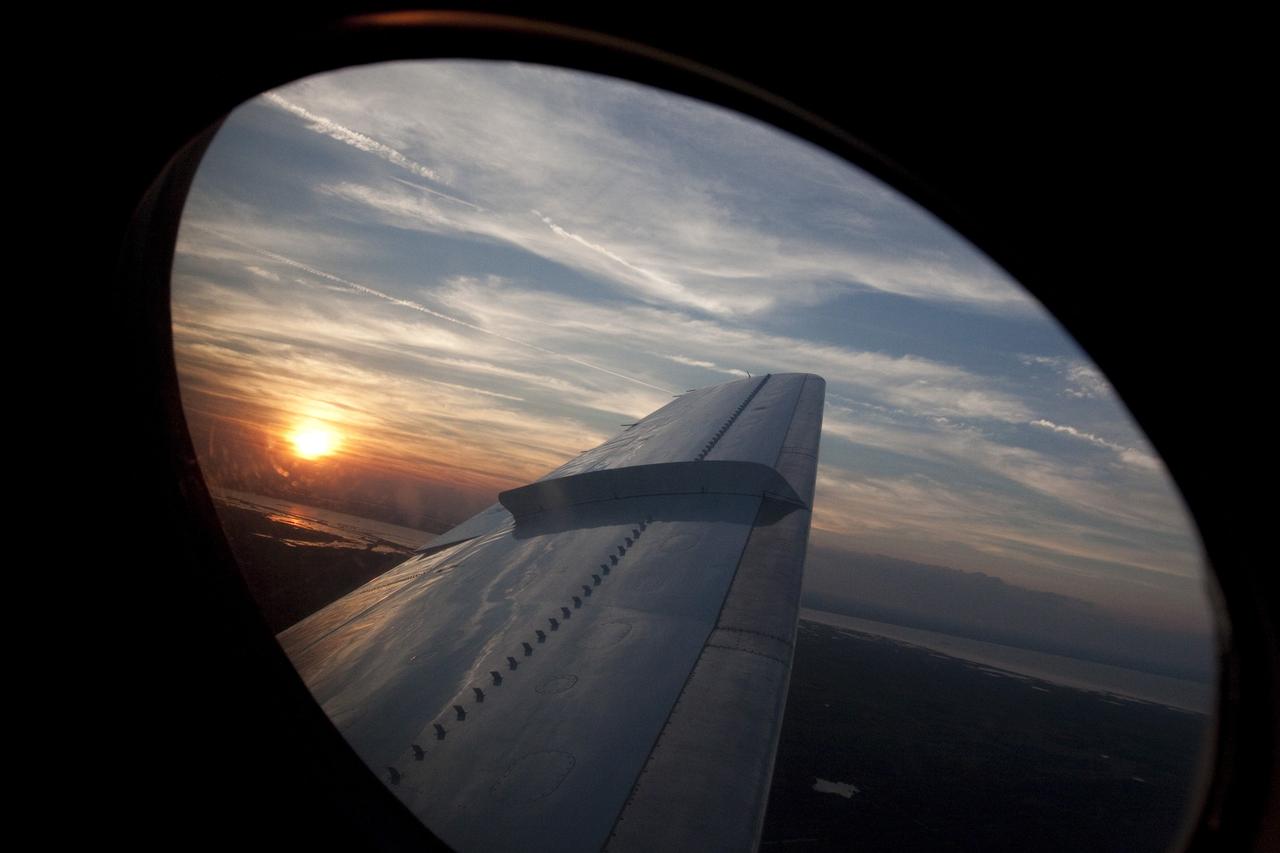 CAPE CANAVERAL, Fla. -- This photo shows the wing of A Shuttle Training Aircraft (STA) as it performs touch-and-go landings on the Shuttle Landing Facility runway at NASA's Kennedy Space Center in Florida. STS-133 Commander Steve Lindsey and Pilot Eric Boe flew two of the Gulfstream II business jets that are modified to mimic the shuttle's handling during the final phase of landing. Practice landings are part of the Terminal Countdown Demonstration Test (TCDT), which provides each shuttle crew and launch team an opportunity to participate in various simulated activities, including equipment familiarization and emergency training at the launch pad.      Space shuttle Discovery and its STS-133 crew will deliver the Permanent Multipurpose Module, packed with supplies and critical spare parts, as well as Robonaut 2, the dexterous humanoid astronaut helper, to the International Space Station. Launch is targeted for Nov. 1 at 4:40 p.m. For more information on the STS-133 mission, visit www.nasa.gov/mission_pages/shuttle/shuttlemissions/sts133/. Photo credit: NASA/Jack Pfaller