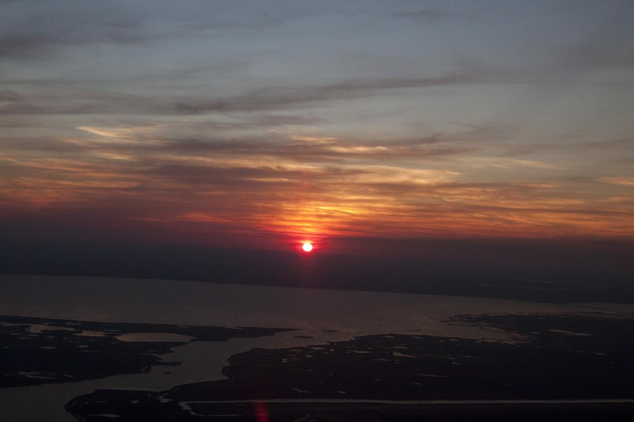 CAPE CANAVERAL, Fla. -- While performing touch-and-go landings over the Shuttle Landing Facility runway, STS-133 Commander Steve Lindsey and Pilot Eric Boe enjoyed a perfect sunset over NASA's Kennedy Space Center in Florida. Lindsey and Boe flew two Shuttle Training Aircraft (STA), which are Gulfstream II business jets modified to mimic the shuttle's handling during the final phase of landing. Practice landings are part of the Terminal Countdown Demonstration Test (TCDT), which provides each shuttle crew and launch team an opportunity to participate in various simulated activities, including equipment familiarization and emergency training at the launch pad.      Space shuttle Discovery and its STS-133 crew will deliver the Permanent Multipurpose Module, packed with supplies and critical spare parts, as well as Robonaut 2, the dexterous humanoid astronaut helper, to the International Space Station. Launch is targeted for Nov. 1 at 4:40 p.m. For more information on the STS-133 mission, visit www.nasa.gov/mission_pages/shuttle/shuttlemissions/sts133/. Photo credit: NASA/Jack Pfaller
