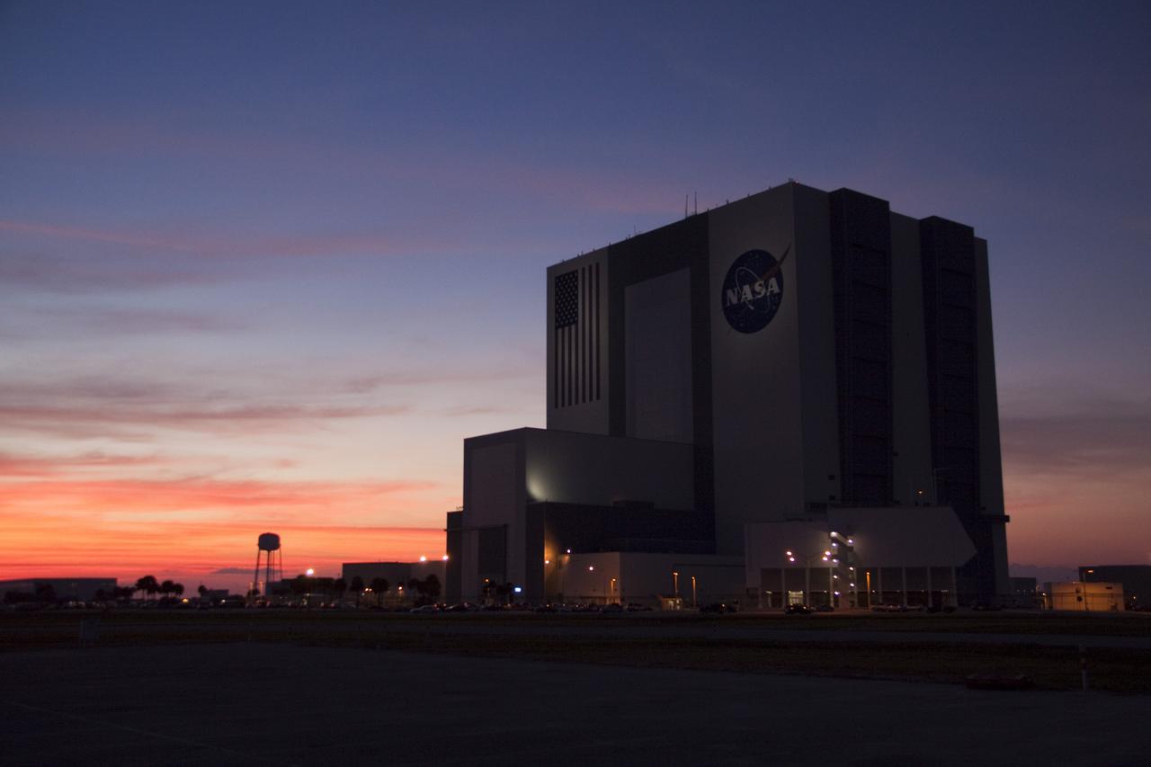 CAPE CANAVERAL, Fla. -- The night lights and Vehicle Assembly Building are silhouetted against the sunset sky over NASA's Kennedy Space Center in Florida.    Photo Credit: NASA/Troy Cryder