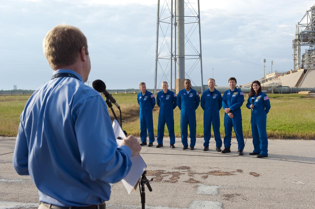CAPE CANAVERAL, Fla. -- At NASA's Kennedy Space Center in Florida, media ask STS-133 Mission Specialist Nicole Stott questions at Launch Pad 39A, where space shuttle Discovery is poised for launch next month. The six STS-133 crew members, from left, are Commander Steve Lindsey, Pilot Eric Boe, and Mission Specialists Alvin Drew, Tim Kopra, Michael Barratt, and Stott. The crew is at Kennedy for the Terminal Countdown Demonstration Test (TCDT), which provides each shuttle crew and launch team an opportunity to participate in various simulated activities, including equipment familiarization and emergency training at the launch pad. Discovery and its crew will deliver the Permanent Multipurpose Module, packed with supplies and critical spare parts, as well as Robonaut 2, the dexterous humanoid astronaut helper, to the International Space Station. Launch is targeted for Nov. 1 at 4:40 p.m. For more information on the STS-133 mission, visit www.nasa.gov/mission_pages/shuttle/shuttlemissions/sts133/. Photo credit: NASA/Kim Shiflett