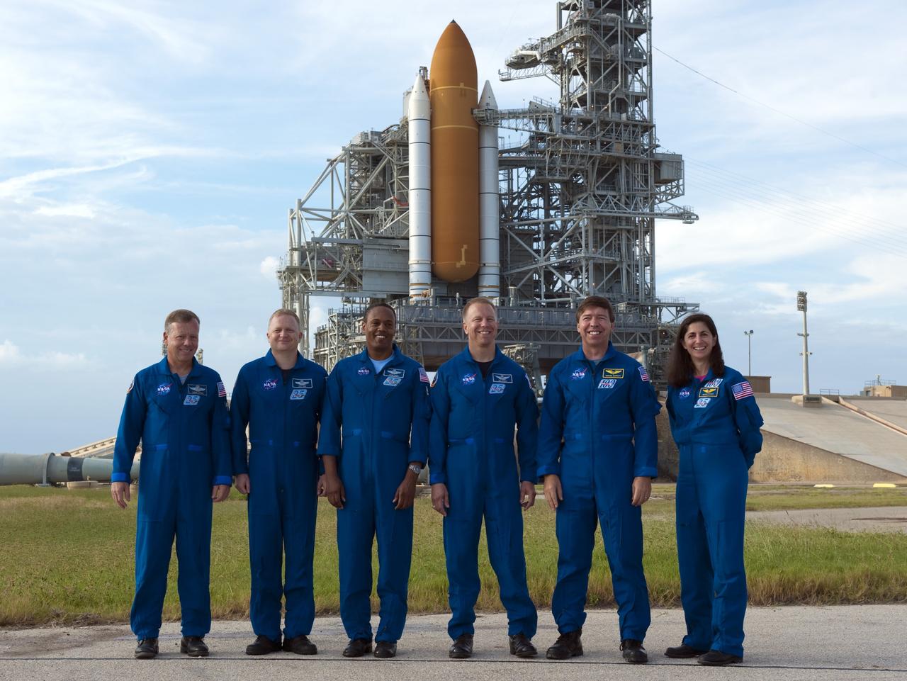 CAPE CANAVERAL, Fla. -- At NASA's Kennedy Space Center in Florida, the six-member crew of STS-133 pose for a group photo at Launch Pad 39A, where space shuttle Discovery is poised for launch next month. From left, are Commander Steve Lindsey, Pilot Eric Boe, and Mission Specialists Alvin Drew, Tim Kopra, Michael Barratt, and Nicole Stott. The crew is at Kennedy for the Terminal Countdown Demonstration Test (TCDT), which provides each shuttle crew and launch team an opportunity to participate in various simulated activities, including equipment familiarization and emergency training at the launch pad. Discovery and its crew will deliver the Permanent Multipurpose Module, packed with supplies and critical spare parts, as well as Robonaut 2, the dexterous humanoid astronaut helper, to the International Space Station. Launch is targeted for Nov. 1 at 4:40 p.m. For more information on the STS-133 mission, visit www.nasa.gov/mission_pages/shuttle/shuttlemissions/sts133/. Photo credit: NASA/Kim Shiflett