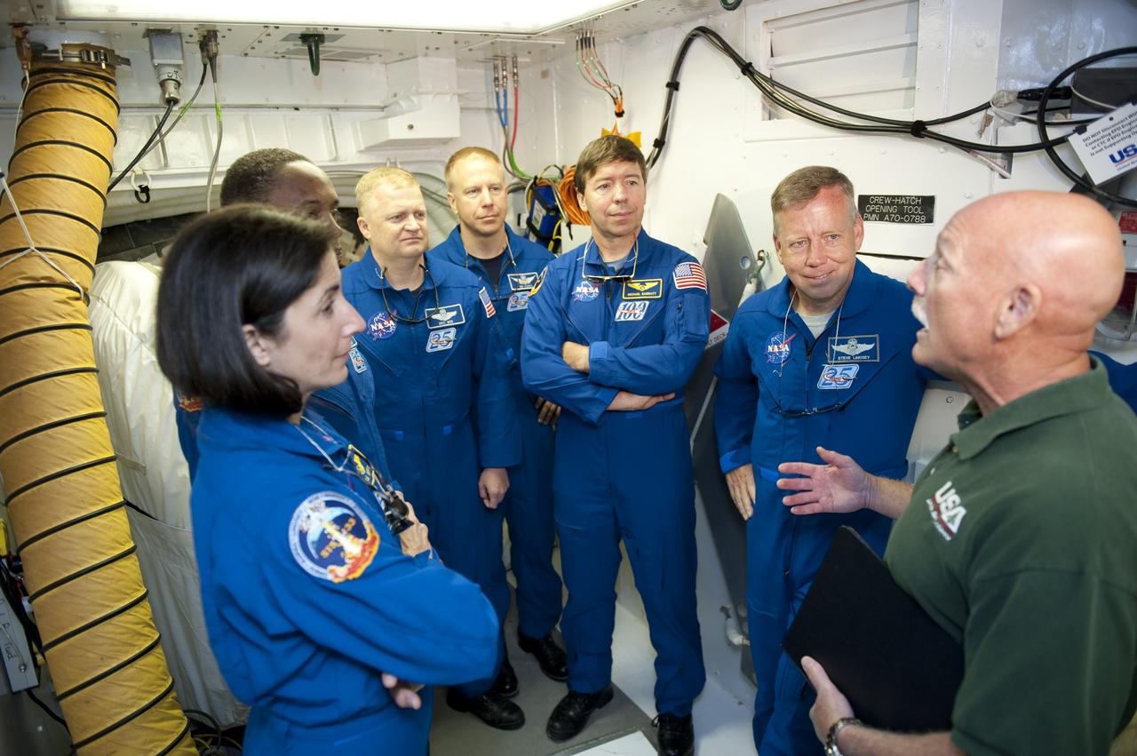CAPE CANAVERAL, Fla. -- At NASA's Kennedy Space Center in Florida, STS-133 crew members pose for a photo in Launch Pad 39A's White Room during the Terminal Countdown Demonstration Test (TCDT). From left are Mission Specialists Nicole Stott, Alvin Drew, Pilot Eric Boe, Mission Specialists Tim Kopra and Michael Barratt, and Commander Steve Lindsey.      TCDT provides each shuttle crew and launch team an opportunity to participate in various simulated activities, including equipment familiarization and a launch countdown. Space shuttle Discovery and its STS-133 crew will deliver the Permanent Multipurpose Module, packed with supplies and critical spare parts, as well as Robonaut 2, the dexterous humanoid astronaut helper, to the International Space Station. Launch is targeted for Nov. 1 at 4:40 p.m. For more information on the STS-133 mission, visit www.nasa.gov/mission_pages/shuttle/shuttlemissions/sts133/. Photo credit: NASA/Kim Shiflett