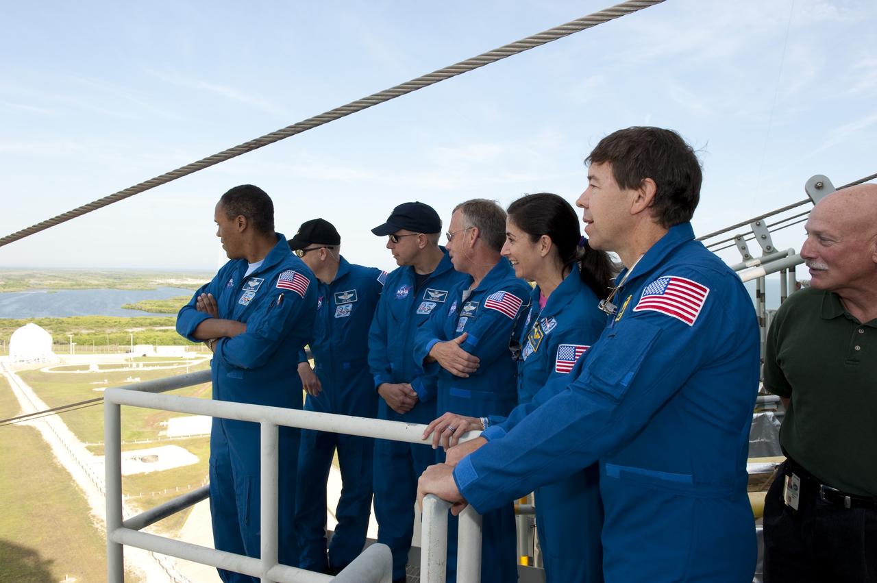 CAPE CANAVERAL, Fla. -- On Launch Pad 39A at NASA's Kennedy Space Center, STS-133 crew members receive instruction on the operation of the pad's slidewire basket system emergency exit training as part of the Terminal Countdown Demonstration Test (TCDT). From left are Mission Specialist Alvin Drew, Pilot Eric Boe, Mission Specialist Tim Kopra, Commander Steve Lindsey, and Mission Specialists Nicole Stott and Michael Barratt.    TCDT provides each shuttle crew and launch team an opportunity to participate in various simulated activities, including equipment familiarization and a launch countdown. Space shuttle Discovery and its STS-133 crew will deliver the Permanent Multipurpose Module, packed with supplies and critical spare parts, as well as Robonaut 2, the dexterous humanoid astronaut helper, to the International Space Station. Launch is targeted for Nov. 1 at 4:40 p.m. For more information on the STS-133 mission, visit www.nasa.gov/mission_pages/shuttle/shuttlemissions/sts133/. Photo credit: NASA/Kim Shiflett