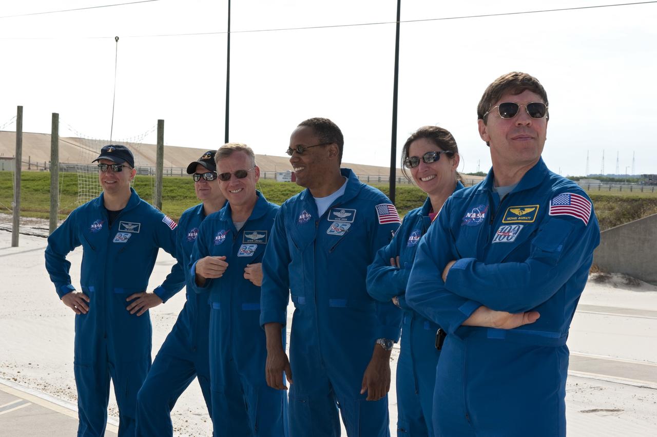 CAPE CANAVERAL, Fla. -- At Launch Pad 39A at NASA's Kennedy Space Center in Florida, members of the STS-133 crew receive instruction by the catch nets for the slidewire baskets at the base of the pad as part of the Terminal Countdown Demonstration Test (TCDT) emergency exit training. From left are Mission Specialist Tim Kopra, Pilot Eric Boe, Commander Steve Lindsey, and Mission Specialists Alvin Drew, Nicole Stott and Michael Barratt.    TCDT provides each shuttle crew and launch team an opportunity to participate in various simulated activities, including equipment familiarization and a launch countdown. Space shuttle Discovery and its STS-133 crew will deliver the Permanent Multipurpose Module, packed with supplies and critical spare parts, as well as Robonaut 2, the dexterous humanoid astronaut helper, to the International Space Station. Launch is targeted for Nov. 1 at 4:40 p.m. For more information on the STS-133 mission, visit www.nasa.gov/mission_pages/shuttle/shuttlemissions/sts133/. Photo credit: NASA/Kim Shiflett