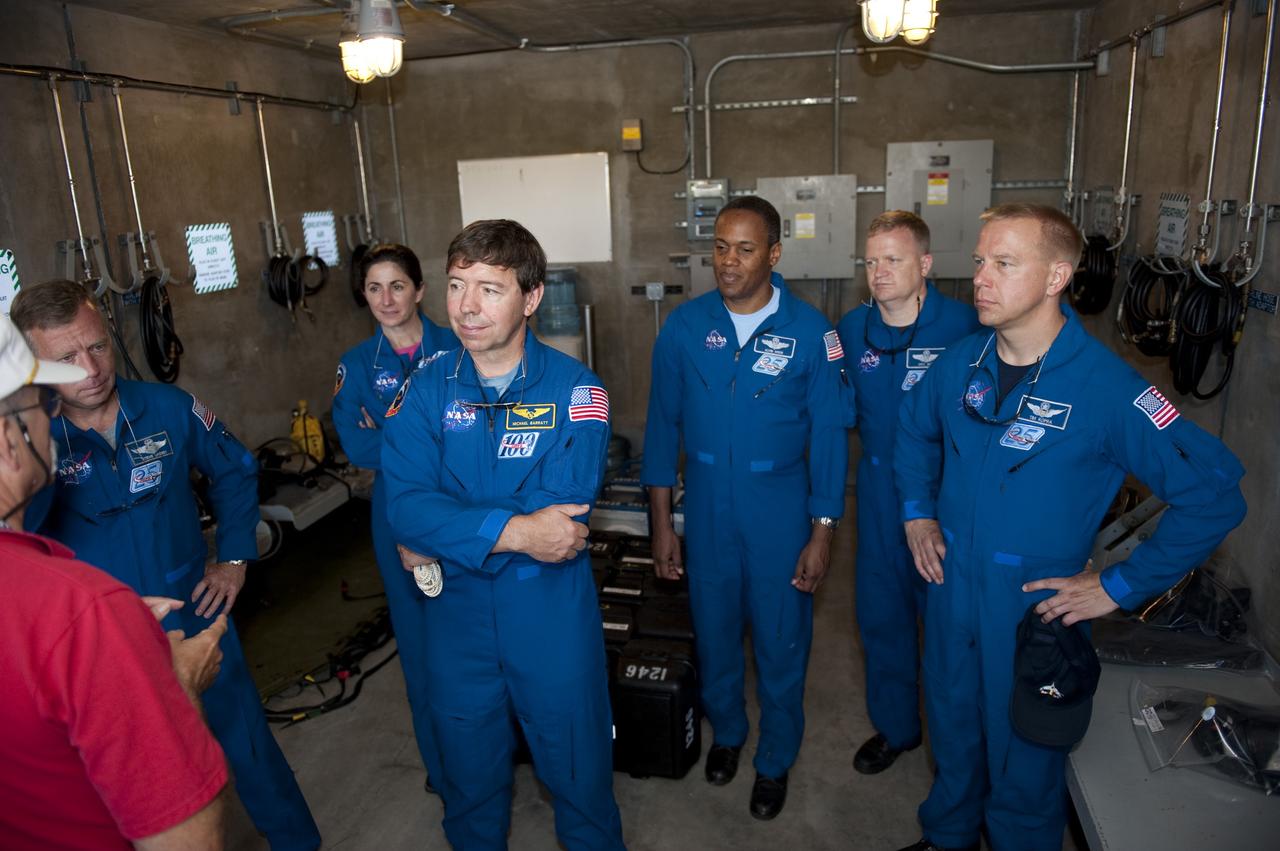 CAPE CANAVERAL, Fla. -- At Launch Pad 39A at NASA's Kennedy Space Center in Florida, members of the STS-133 crew receive instruction in the pad's bunker as part of the Terminal Countdown Demonstration Test (TCDT) emergency exit training. From left are Commander Steve Lindsey, Mission Specialists Nicole Stott, Michael Barratt and Alvin Drew, Pilot Eric Boe, and Mission Specialist Tim Kopra. TCDT provides each shuttle crew and launch team an opportunity to participate in various simulated activities, including equipment familiarization and a launch countdown. Space shuttle Discovery and its STS-133 crew will deliver the Permanent Multipurpose Module, packed with supplies and critical spare parts, as well as Robonaut 2, the dexterous humanoid astronaut helper, to the International Space Station. Launch is targeted for Nov. 1 at 4:40 p.m. For more information on the STS-133 mission, visit www.nasa.gov/mission_pages/shuttle/shuttlemissions/sts133/. Photo credit: NASA/Kim Shiflett