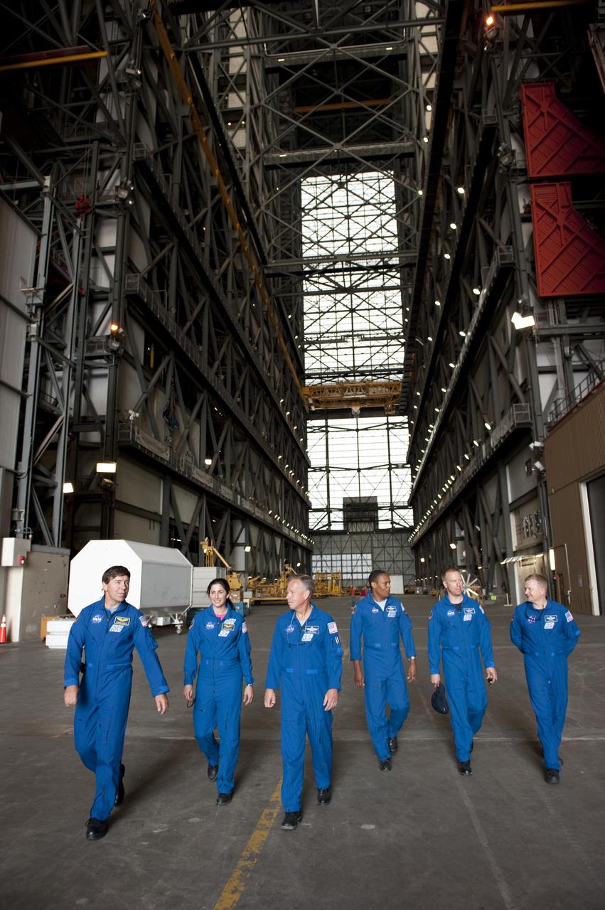 CAPE CANAVERAL, Fla. -- At NASA's Kennedy Space Center in Florida, the STS-133 crew members walk through the Vehicle Assembly Building. From left are Mission Specialists Michael Barratt and Nicole Stott, Commander Steve Lindsey, Mission Specialists Alvin Drew and Tim Kopra, and Pilot Eric Boe. The astronauts are at Kennedy for the Terminal Countdown Demonstration Test (TCDT), which provides each shuttle crew and launch team an opportunity to participate in various simulated activities, including equipment familiarization and a launch countdown.    Space shuttle Discovery and its STS-133 crew will deliver the Permanent Multipurpose Module, packed with supplies and critical spare parts, as well as Robonaut 2, the dexterous humanoid astronaut helper, to the International Space Station. Launch is targeted for Nov. 1 at 4:40 p.m. For more information on the STS-133 mission, visit www.nasa.gov/mission_pages/shuttle/shuttlemissions/sts133/. Photo credit: NASA/Kim Shiflett