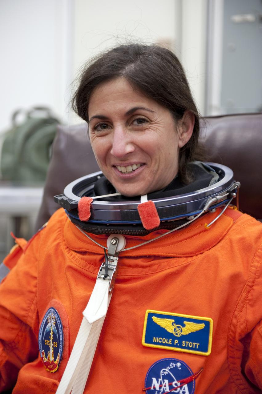 CAPE CANAVERAL, Fla. -- STS-133 Mission Specialist Nicole Stott is suited up in the Operations and Checkout Building at NASA's Kennedy Space Center in Florida during a simulated launch countdown. Checking the fit of their orange launch-and-entry suits and helmets before launch day is part of the Terminal Countdown Demonstration Test (TCDT), which provides each shuttle crew and launch team an opportunity to participate in various simulated activities, including equipment familiarization and emergency training at the launch pad. Space shuttle Discovery and its STS-133 crew will deliver the Permanent Multipurpose Module, packed with supplies and critical spare parts, as well as Robonaut 2, the dexterous humanoid astronaut helper, to the International Space Station. Launch is targeted for Nov. 1 at 4:40 p.m. For more information on the STS-133 mission, visit www.nasa.gov/mission_pages/shuttle/shuttlemissions/sts133/. Photo credit: NASA/Kim Shiflett
