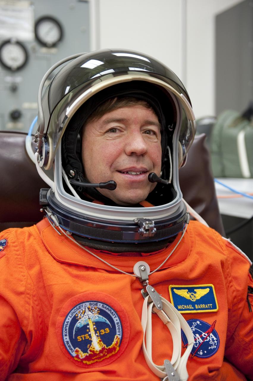 CAPE CANAVERAL, Fla. -- STS-133 Mission Specialist Michael Barratt is suited up in the Operations and Checkout Building at NASA's Kennedy Space Center in Florida during a simulated launch countdown. Checking the fit of their orange launch-and-entry suits and helmets before launch day is part of the Terminal Countdown Demonstration Test (TCDT), which provides each shuttle crew and launch team an opportunity to participate in various simulated activities, including equipment familiarization and emergency training at the launch pad. Space shuttle Discovery and its STS-133 crew will deliver the Permanent Multipurpose Module, packed with supplies and critical spare parts, as well as Robonaut 2, the dexterous humanoid astronaut helper, to the International Space Station. Launch is targeted for Nov. 1 at 4:40 p.m. For more information on the STS-133 mission, visit www.nasa.gov/mission_pages/shuttle/shuttlemissions/sts133/. Photo credit: NASA/Kim Shiflett