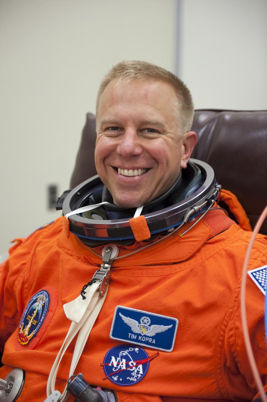 CAPE CANAVERAL, Fla. -- STS-133 Mission Specialist Tim Kopra is suited up in the Operations and Checkout Building at NASA's Kennedy Space Center in Florida during a simulated launch countdown. Checking the fit of their orange launch-and-entry suits and helmets before launch day is part of the Terminal Countdown Demonstration Test (TCDT), which provides each shuttle crew and launch team an opportunity to participate in various simulated activities, including equipment familiarization and emergency training at the launch pad. Space shuttle Discovery and its STS-133 crew will deliver the Permanent Multipurpose Module, packed with supplies and critical spare parts, as well as Robonaut 2, the dexterous humanoid astronaut helper, to the International Space Station. Launch is targeted for Nov. 1 at 4:40 p.m. For more information on the STS-133 mission, visit www.nasa.gov/mission_pages/shuttle/shuttlemissions/sts133/. Photo credit: NASA/Kim Shiflett