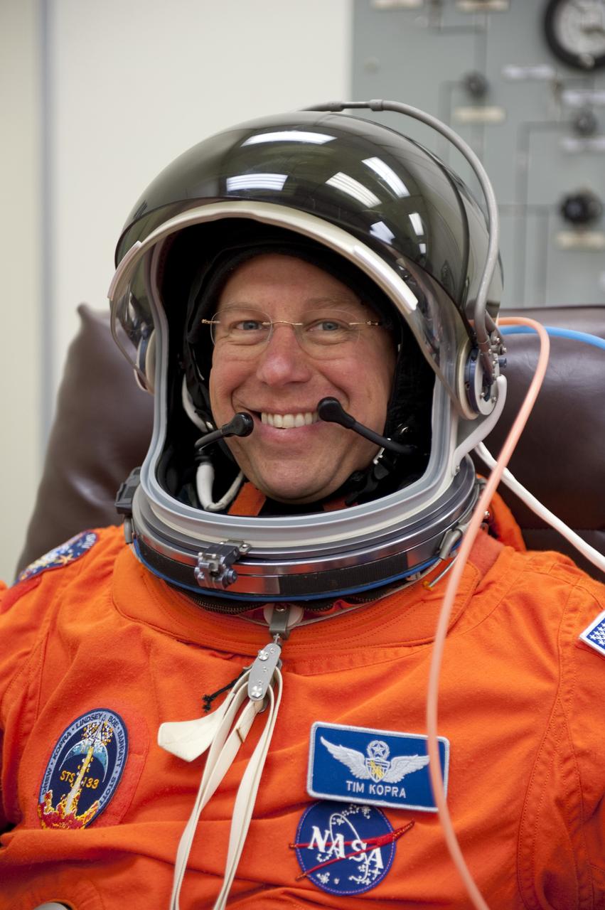 CAPE CANAVERAL, Fla. -- STS-133 Mission Specialist Tim Kopra is suited up in the Operations and Checkout Building at NASA's Kennedy Space Center in Florida during a simulated launch countdown. Checking the fit of their orange launch-and-entry suits and helmets before launch day is part of the Terminal Countdown Demonstration Test (TCDT), which provides each shuttle crew and launch team an opportunity to participate in various simulated activities, including equipment familiarization and emergency training at the launch pad. Space shuttle Discovery and its STS-133 crew will deliver the Permanent Multipurpose Module, packed with supplies and critical spare parts, as well as Robonaut 2, the dexterous humanoid astronaut helper, to the International Space Station. Launch is targeted for Nov. 1 at 4:40 p.m. For more information on the STS-133 mission, visit www.nasa.gov/mission_pages/shuttle/shuttlemissions/sts133/. Photo credit: NASA/Kim Shiflett