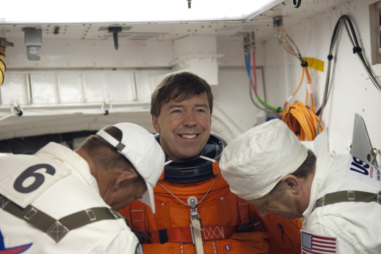 CAPE CANAVERAL, Fla. -- In the White Room of Launch Pad 39A at NASA's Kennedy Space Center in Florida, STS-133 Mission Specialist Michael Barratt prepares to board space shuttle Discovery during the Terminal Countdown Demonstration Test (TCDT). Part of TCDT includes practicing the final hours of a real launch day when astronauts put on their launch-and-entry suits, ride to the pad in the Astrovan and strap into the shuttle.    Discovery and its STS-133 crew will deliver the Permanent Multipurpose Module, packed with supplies and critical spare parts, as well as Robonaut 2, the dexterous humanoid astronaut helper, to the International Space Station. Launch is targeted for Nov. 1 at 4:40 p.m. For more information on the STS-133 mission, visit www.nasa.gov/mission_pages/shuttle/shuttlemissions/sts133/. Photo credit: NASA/Jim Grossmann