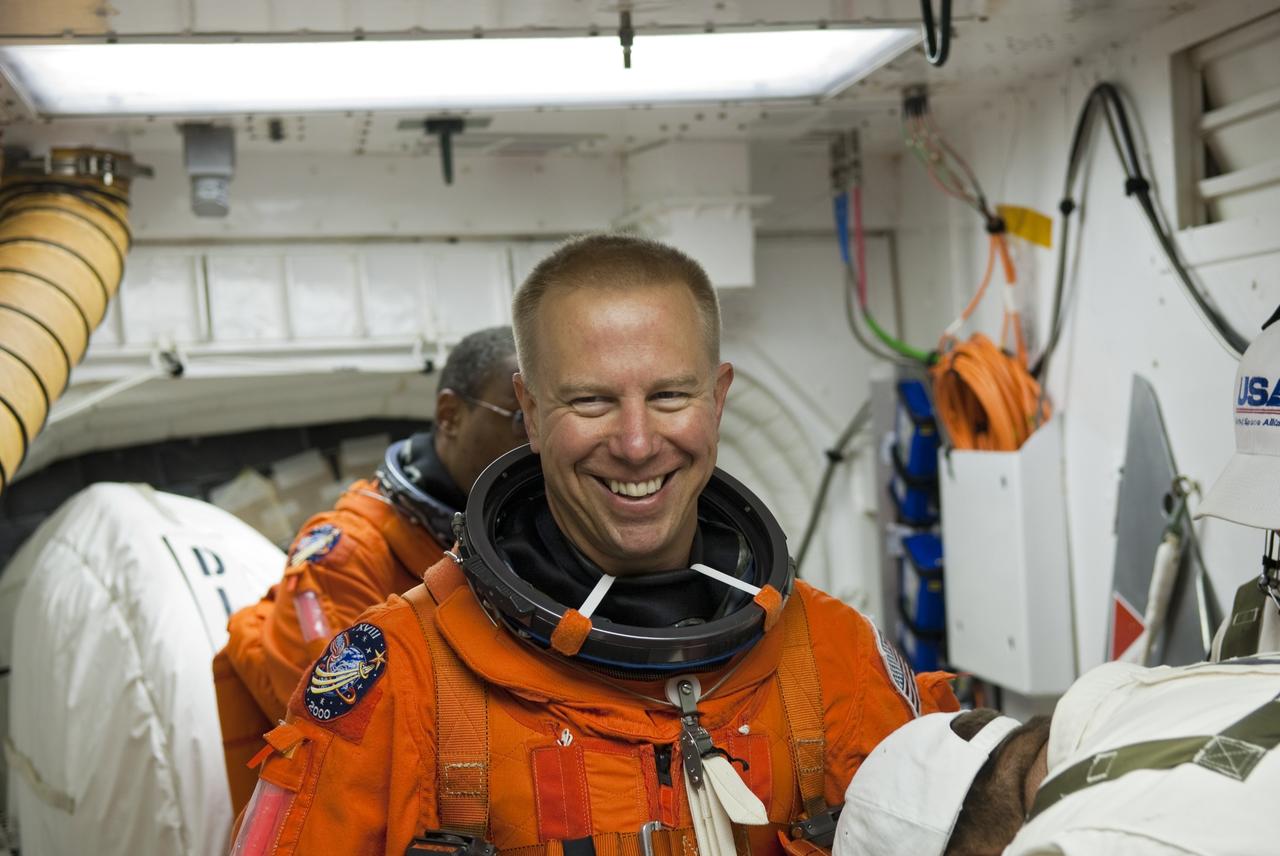 CAPE CANAVERAL, Fla. -- In the White Room of Launch Pad 39A at NASA's Kennedy Space Center in Florida, STS-133 Mission Specialist Tim Kopra prepares to board space shuttle Discovery during the Terminal Countdown Demonstration Test (TCDT). Part of TCDT includes practicing the final hours of a real launch day when astronauts put on their launch-and-entry suits, ride to the pad in the Astrovan and strap into the shuttle.    Discovery and its STS-133 crew will deliver the Permanent Multipurpose Module, packed with supplies and critical spare parts, as well as Robonaut 2, the dexterous humanoid astronaut helper, to the International Space Station. Launch is targeted for Nov. 1 at 4:40 p.m. For more information on the STS-133 mission, visit www.nasa.gov/mission_pages/shuttle/shuttlemissions/sts133/. Photo credit: NASA/Jim Grossmann