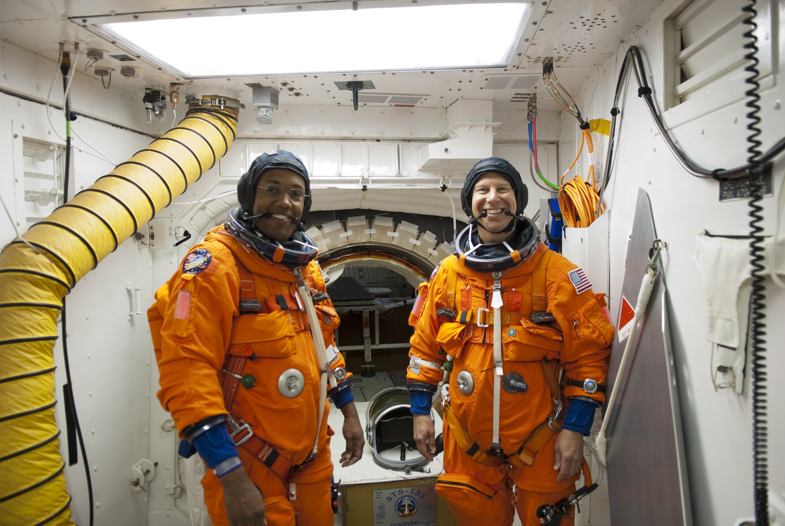CAPE CANAVERAL, Fla. -- In the White Room of Launch Pad 39A at NASA's Kennedy Space Center in Florida, STS-133 Mission Specialists Alvin Drew, left, and Tim Kopra prepare to board space shuttle Discovery during the Terminal Countdown Demonstration Test (TCDT). Part of TCDT includes practicing the final hours of a real launch day when astronauts put on their launch-and-entry suits, ride to the pad in the Astrovan and strap into the shuttle.    Discovery and its STS-133 crew will deliver the Permanent Multipurpose Module, packed with supplies and critical spare parts, as well as Robonaut 2, the dexterous humanoid astronaut helper, to the International Space Station. Launch is targeted for Nov. 1 at 4:40 p.m. For more information on the STS-133 mission, visit www.nasa.gov/mission_pages/shuttle/shuttlemissions/sts133/. Photo credit: NASA/Jim Grossmann