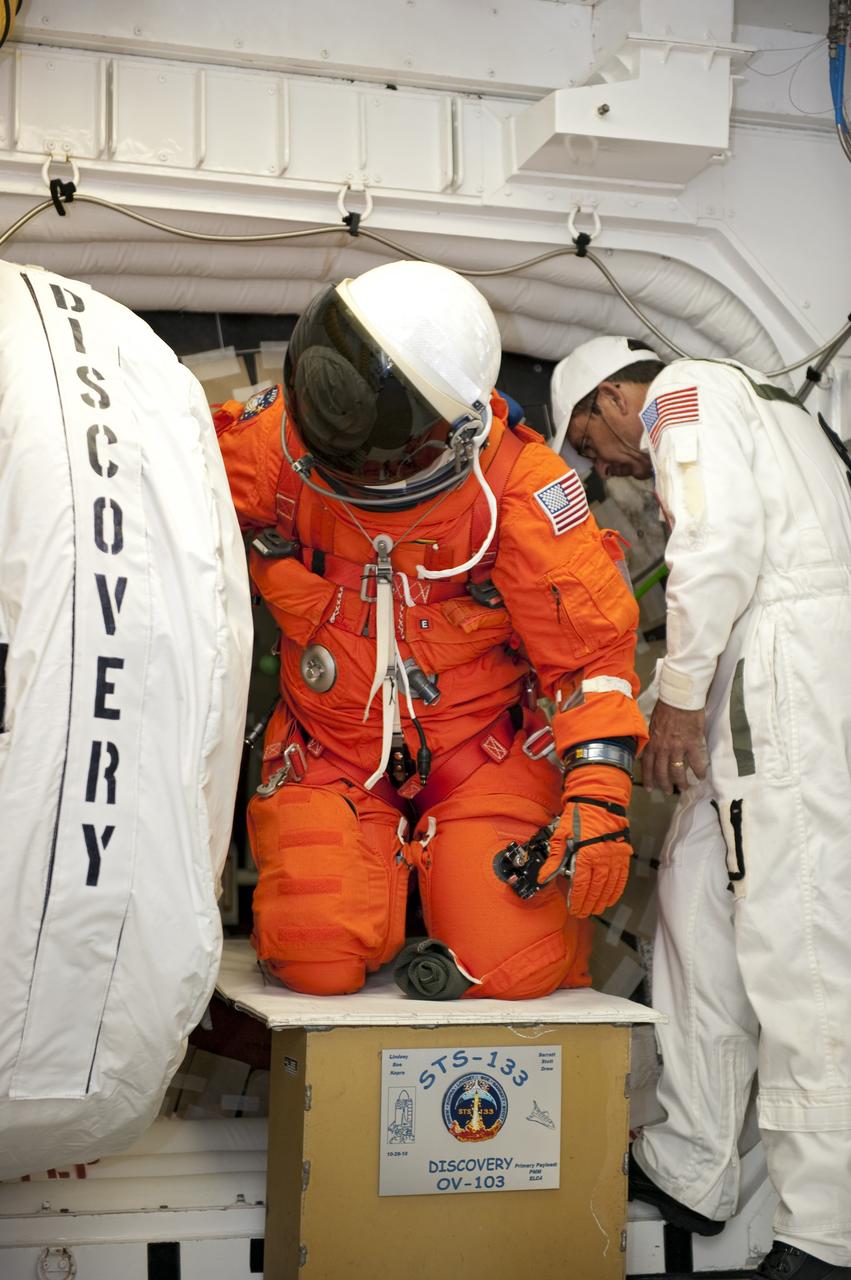 CAPE CANAVERAL, Fla. -- During a simulated pad emergency on Launch Pad 39A at NASA's Kennedy Space Center in Florida, STS-133 Mission Specialist Michael Barratt exits space shuttle Discovery through the pad's White Room. Next, the crew members will hop into the slidewire basket that will take them to a safe bunker below the pad. The emergency training is part of a week-long Terminal Countdown Demonstration Test (TCDT). Discovery and its STS-133 crew will deliver the Permanent Multipurpose Module, packed with supplies and critical spare parts, as well as Robonaut 2, the dexterous humanoid astronaut helper, to the International Space Station. Launch is targeted for Nov. 1 at 4:40 p.m. For more information on the STS-133 mission, visit www.nasa.gov/mission_pages/shuttle/shuttlemissions/sts133/. Photo credit: NASA/Kim Shiflett