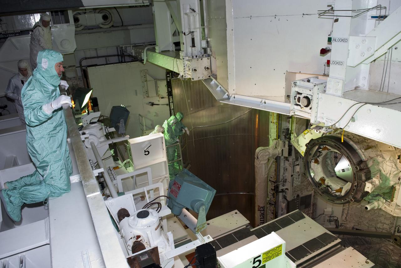 CAPE CANAVERAL, Fla. -- At NASA's Kennedy Space Center in Florida, STS-133 Mission Specialist Michael Barratt, foreground, checks out his mission's payload while at Launch Pad 39A for the Terminal Countdown Demonstration Test (TCDT).     Discovery and its STS-133 crew will deliver the Permanent Multipurpose Module, packed with supplies and critical spare parts, as well as Robonaut 2, the dexterous humanoid astronaut helper, to the International Space Station. Launch is targeted for 4:40 p.m. EDT, Nov. 1. Photo credit: NASA/Jim Grossmann