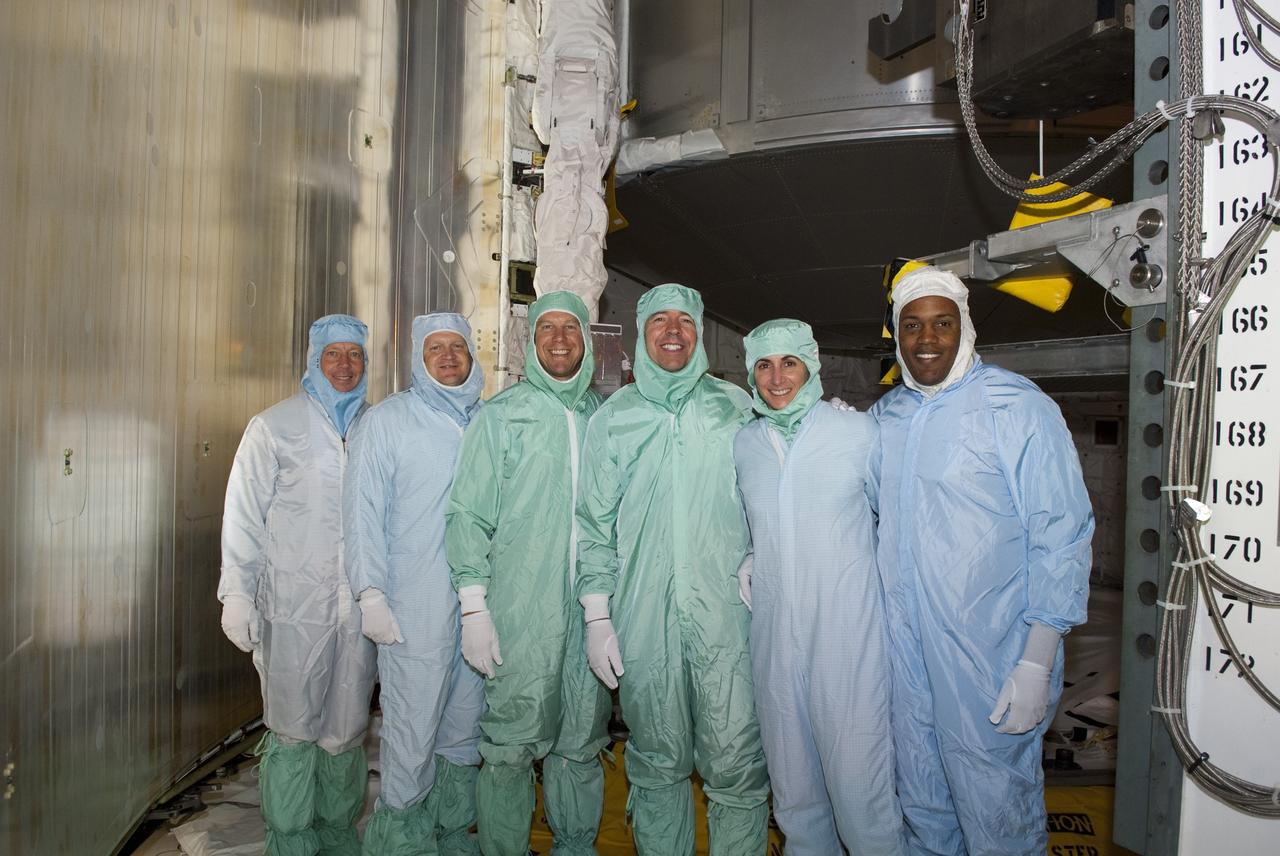 CAPE CANAVERAL, Fla. -- At NASA's Kennedy Space Center in Florida, STS-133 crew members pose for a photo after checking out their mission's payload while at Launch Pad 39A for the Terminal Countdown Demonstration Test (TCDT). From left, are Commander Steve Lindsey, Pilot Eric Boe, and Mission Specialists Tim Kopra, Michael Barratt, Nicole Stott, and Alvin Drew.     Discovery and its STS-133 crew will deliver the Permanent Multipurpose Module, packed with supplies and critical spare parts, as well as Robonaut 2, the dexterous humanoid astronaut helper, to the International Space Station. Launch is targeted for 4:40 p.m. EDT, Nov. 1. Photo credit: NASA/Jim Grossmann