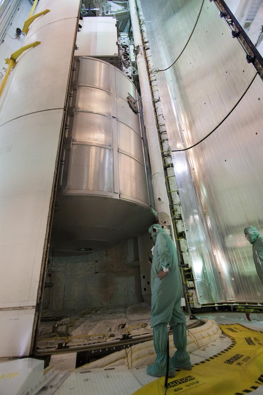CAPE CANAVERAL, Fla. -- On Launch Pad 39A at NASA's Kennedy Space Center in Florida, technicians close the clamshell doors of space shuttle Discovery's payload bay in preparation for the STS-133 launch to the International Space Station.      Targeted to launch Nov. 1, STS-133 will carry the Permanent Multipurpose Module (PMM) packed with supplies and critical spare parts, as well as Robonaut 2 (R2) to the station. Photo credit: NASA/Jack Pfaller