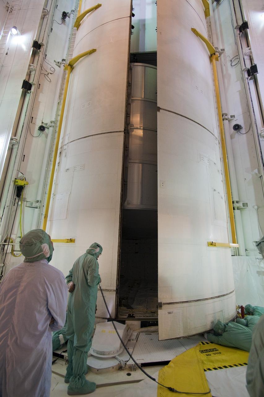 CAPE CANAVERAL, Fla. -- On Launch Pad 39A at NASA's Kennedy Space Center in Florida, technicians close the clamshell doors of space shuttle Discovery's payload bay in preparation for the STS-133 launch to the International Space Station.    Targeted to launch Nov. 1, STS-133 will carry the Permanent Multipurpose Module (PMM) packed with supplies and critical spare parts, as well as Robonaut 2 (R2) to the station. Photo credit: NASA/Jack Pfaller