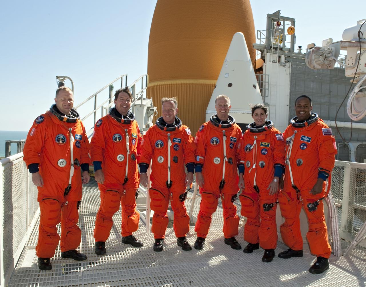 CAPE CANAVERAL, Fla. -- At NASA's Kennedy Space Center in Florida, the STS-133 crew takes a break from a simulated launch countdown and simulated pad emergency to take a group photo on the 195-foot level of Launch Pad 39A. From left are, Pilot Eric Boe, Mission Specialist Michael Barratt, Commander Steve Lindsey, and Mission Specialists Tim Kopra, Nicole Stott, and Alvin Drew. The simulations are part of a week-long Terminal Countdown Demonstration Test (TCDT). Discovery and its STS-133 crew will deliver the Permanent Multipurpose Module, packed with supplies and critical spare parts, as well as Robonaut 2, the dexterous humanoid astronaut helper, to the International Space Station. Launch is targeted for Nov. 1 at 4:40 p.m. For more information on the STS-133 mission, visit www.nasa.gov/mission_pages/shuttle/shuttlemissions/sts133/. Photo credit: NASA/Kim Shiflett