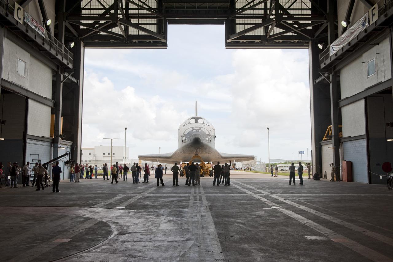 CAPE CANAVERAL, Fla. -- At NASA's Kennedy Space Center in Florida, shuttle Discovery is ushered into the Vehicle Assembly Building (VAB) from Orbiter Processing Facility-3 during a move known as "rollover." Once inside the VAB, the shuttle will be joined to its solid rocket boosters and external fuel tank. Later, Discovery will "roll out" to Launch Pad 39A for its launch to the International Space Station on the STS-133 mission.       Targeted to liftoff Nov. 1, Discovery will take the Permanent Multipurpose Module (PMM) packed with supplies and critical spare parts, as well as Robonaut 2 (R2) to the station.  Photo credit: NASA/Ben Cooper