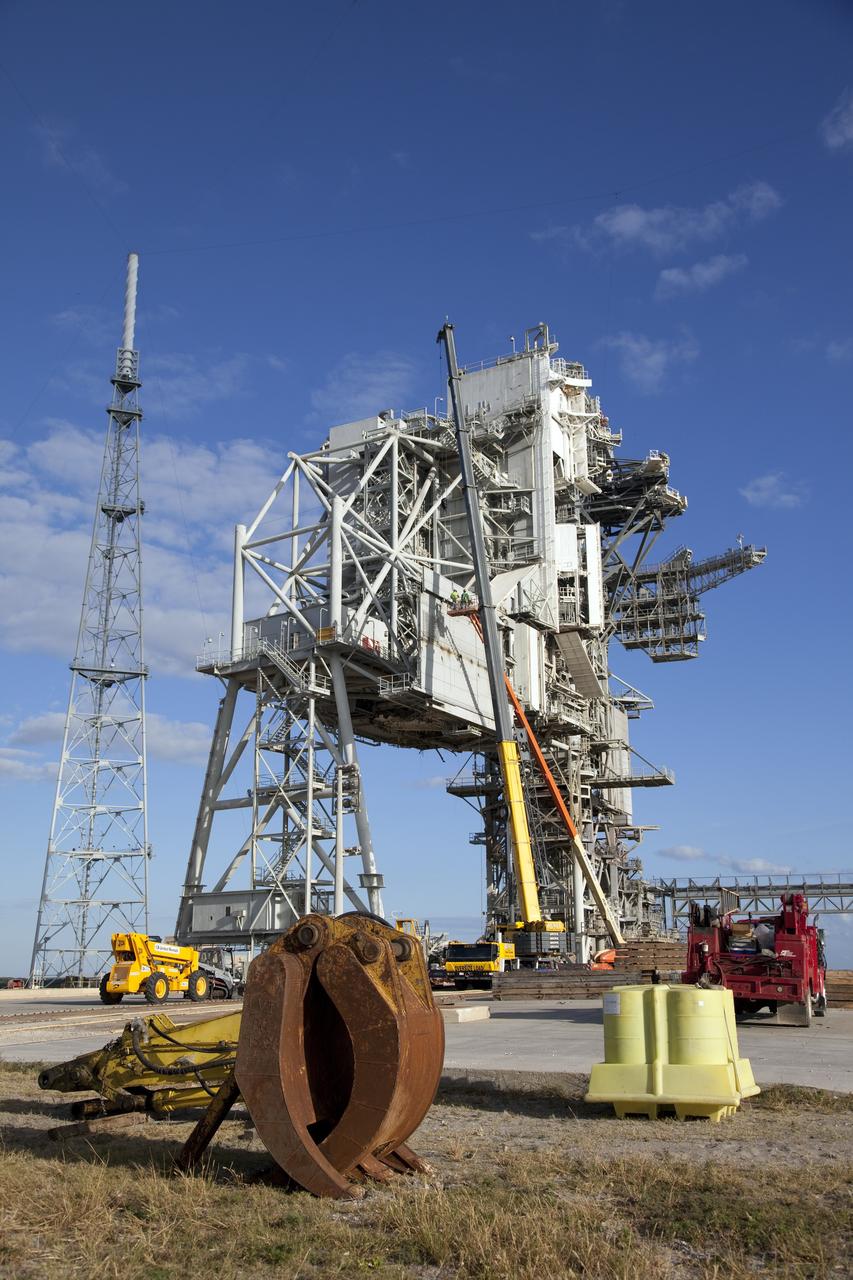 CAPE CANAVERAL, Fla. -- At NASA's Kennedy Space Center in Florida, the rotating service structure (RSS) on Launch Pad 39B is being dismantled. Starting in 2009, the structure at the pad was no longer needed for NASA's Space Shuttle Program, so it is being restructured for future use. The new design will feature a "clean pad" for rockets to come with their own launcher, making it more versatile for a number of vehicles. The new lightning protection system, left, will remain.          For information on NASA's future plans, visit www.nasa.gov. Photo credit: NASA/Frankie Martin