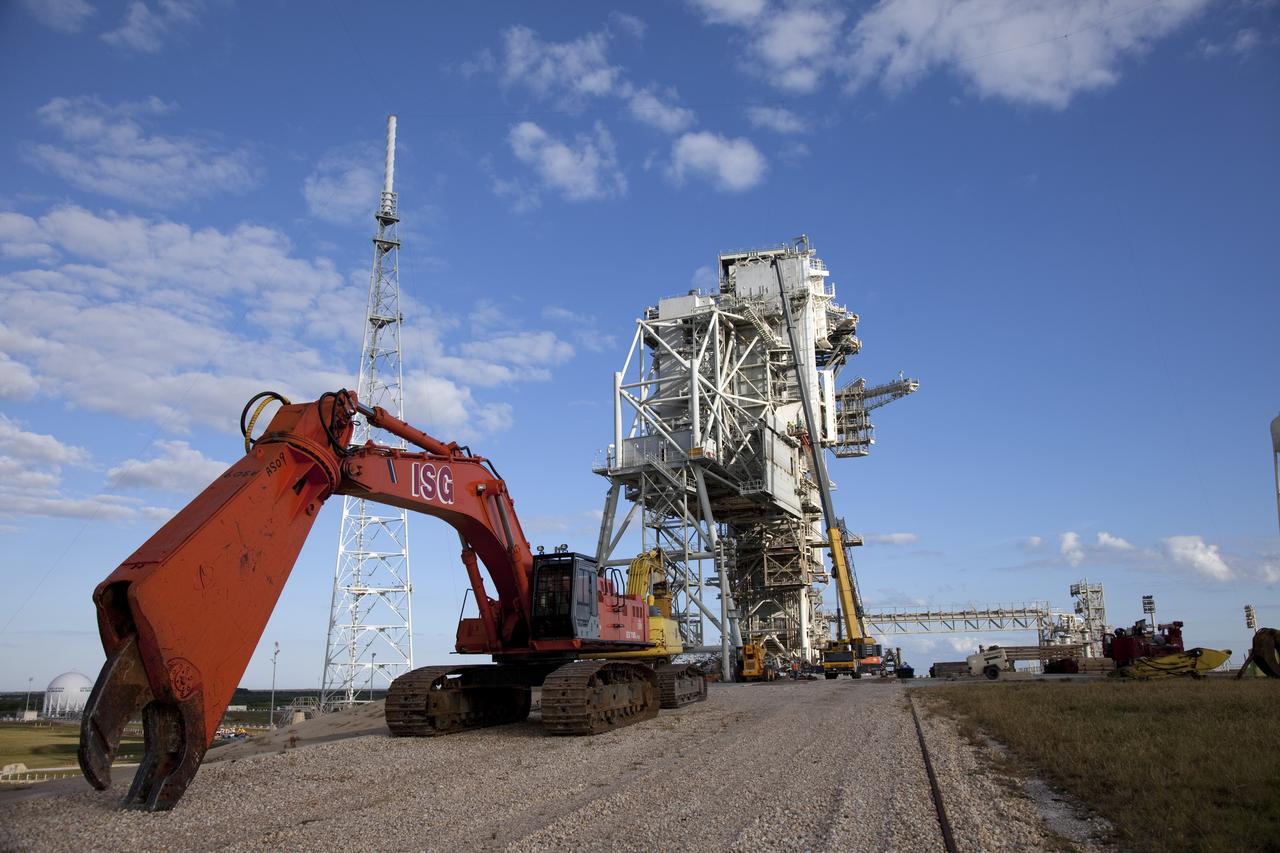CAPE CANAVERAL, Fla. -- At NASA's Kennedy Space Center in Florida, the rotating service structure (RSS) on Launch Pad 39B is being dismantled. Starting in 2009, the structure at the pad was no longer needed for NASA's Space Shuttle Program, so it is being restructured for future use. The new design will feature a "clean pad" for rockets to come with their own launcher, making it more versatile for a number of vehicles. The new lightning protection system, left, will remain.        For information on NASA's future plans, visit www.nasa.gov. Photo credit: NASA/Frankie Martin