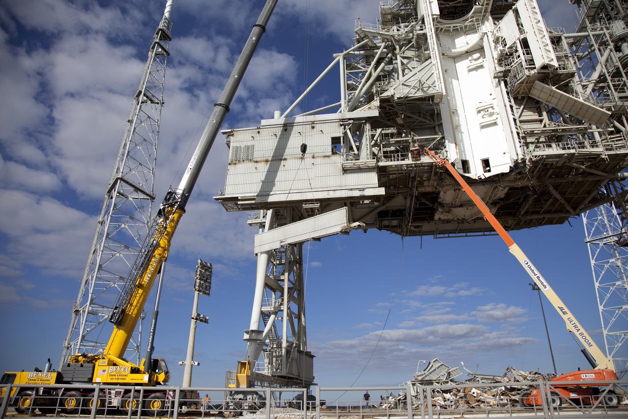CAPE CANAVERAL, Fla. -- At NASA's Kennedy Space Center in Florida, the rotating service structure (RSS) on Launch Pad 39B is being dismantled. Starting in 2009, the structure at the pad was no longer needed for NASA's Space Shuttle Program, so it is being restructured for future use. The new design will feature a "clean pad" for rockets to come with their own launcher, making it more versatile for a number of vehicles. The new lightning protection system, left, will remain.    For information on NASA's future plans, visit www.nasa.gov. Photo credit: NASA/Frankie Martin