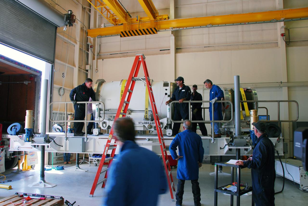 VANDENBERG AIR FORCE BASE, Calif. -- At Vandenberg Air Force Base in California, the second stage of the Pegasus XL rocket, left, that will launch the Nuclear Spectroscopic Telescope Array (NuSTAR) to orbit is moved onto a jackable rail for processing in Building 1555. On the right is the rocket's third stage. After the rocket and spacecraft are processed at Vandenberg, they will be shipped to the Ronald Reagan Ballistic Missile Defense Test Site located at the Pacific Ocean’s Kwajalein Atoll for launch.  The high-energy X-ray telescope will conduct a census for black holes, map radioactive material in young supernovae remnants, and study the origins of cosmic rays and the extreme physics around collapsed stars. Photo credit: NASA/Dan Liberotti, VAFB