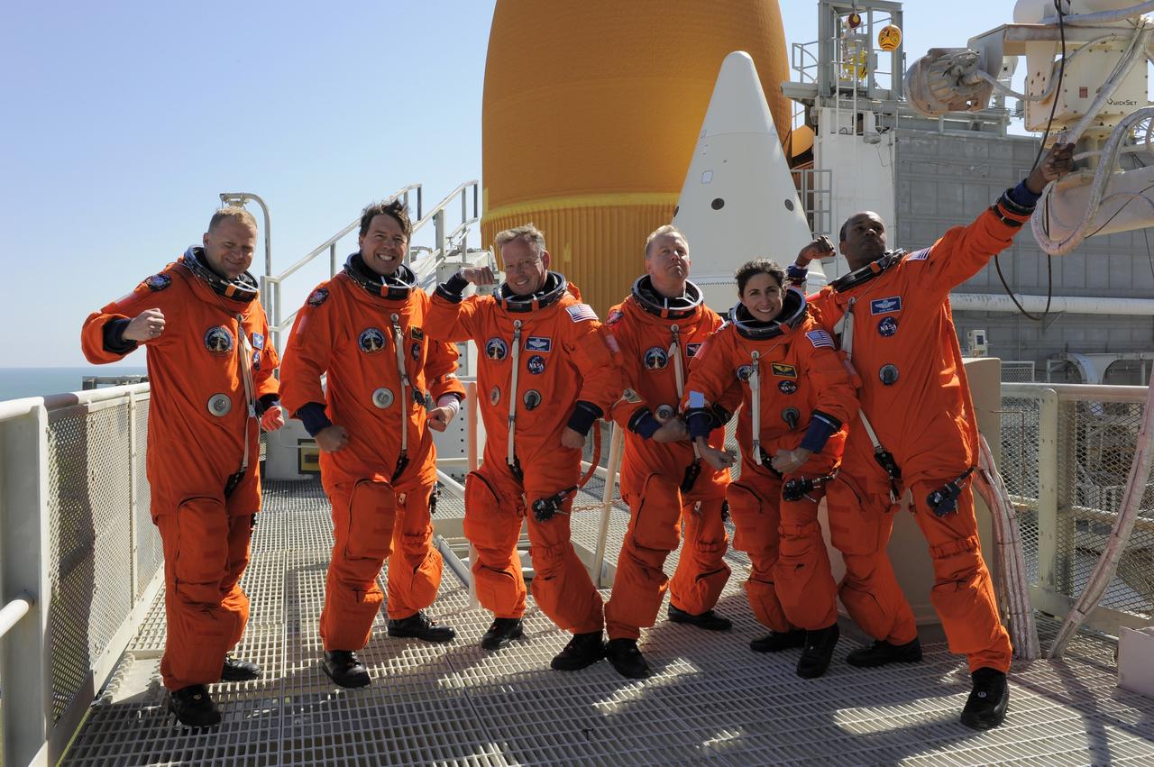CAPE CANAVERAL, Fla. -- At NASA's Kennedy Space Center in Florida, the STS-133 crew takes a break from a simulated launch countdown to ham it up on the 195-foot level of Launch Pad 39A. From left are, Pilot Eric Boe, Mission Specialist Michael Barratt, Commander Steve Lindsey, and Mission Specialists Tim Kopra, Nicole Stott, and Alvin Drew. The simulation is part of a week-long Terminal Countdown Demonstration Test (TCDT).    Discovery and its STS-133 crew will deliver the Permanent Multipurpose Module, packed with supplies and critical spare parts, as well as Robonaut 2, the dexterous humanoid astronaut helper, to the International Space Station. Launch is targeted for Nov. 1 at 4:40 p.m. For more information on the STS-133 mission, visit www.nasa.gov/mission_pages/shuttle/shuttlemissions/sts133/. Photo credit: NASA/Kim Shiflett