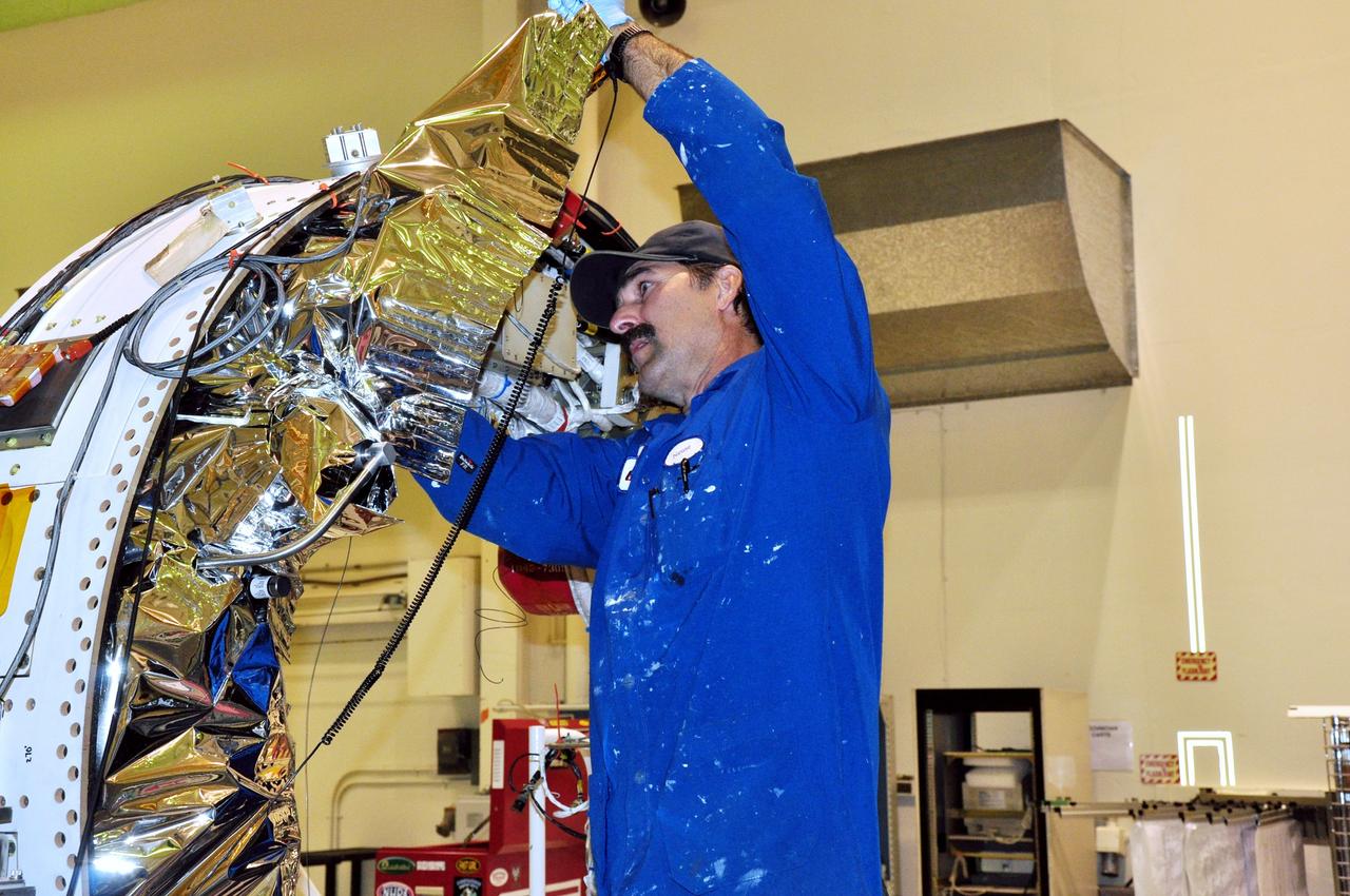 VANDENBERG AIR FORCE BASE, Calif. – In Building 1555 at Vandenberg Air Force Base in California, a technician installs the aft-end blankets on the avionics assembly of a four-stage Taurus XL rocket. The rocket and NASA's Glory satellite are being prepared for a launch to low Earth orbit from Vandenberg's Space Launch Complex 576-E.    Once Glory reaches orbit, it will collect data on the properties of aerosols and black carbon. It also will help scientists understand how the sun's irradiance affects Earth's climate.  Photo credit: NASA/Randy Beaudoin, VAFB