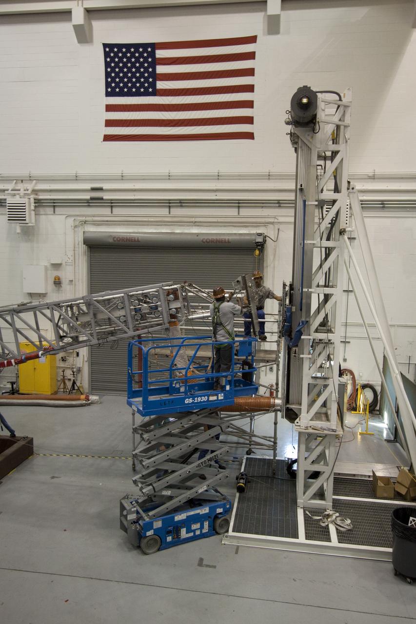 CAPE CANAVERAL, Fla. -- At NASA's Kennedy Space Center in Florida, testing of the Tilt-Up Umbilical Arm (TUUA) prototype's Environmental Control System Quick Disconnect takes place in the Launch Equipment Test Facility's 6,000-square-foot high bay. The prototype is used to demonstrate the safe disconnect and retraction of ground umbilical plates and associated hardware of a launch vehicle's upper stage and service module. The Environmental Control System consists of regulated air, which would be used to purge an inner tank and crew module. Since 1977, the facility has supported NASA’s Launch Services, shuttle, International Space Station, and Constellation programs, as well as commercial providers. The facility recently underwent a major upgrade to support even more programs, projects and customers. It houses a cable fabrication and molding shop, pneumatics shop, machine and weld shop and full-scale control room. Outside, the facility features a water flow test loop, vehicle motion simulator, 600-ton test fixture, launch simulation towers and a cryogenic system. Photo credit: NASA/Jack Pfaller