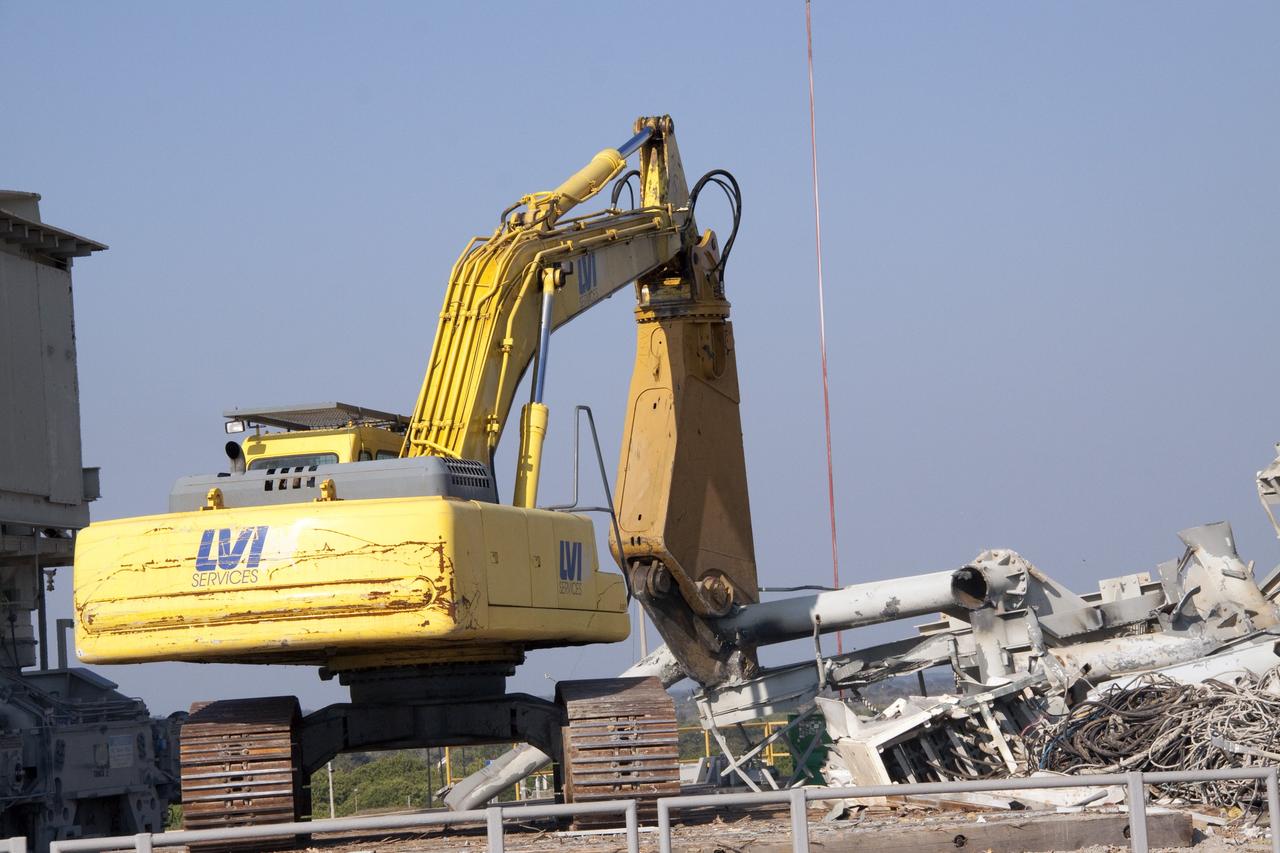 CAPE CANAVERAL, Fla. -- Rubble begins to build as the rotating service structure (RSS) on Launch Pad 39B is dismantled at NASA's Kennedy Space Center in Florida. Starting in 2009, the structure at the pad was no longer needed for NASA's Space Shuttle Program, so it is being restructured for future use. The new design will feature a "clean pad" for rockets to come with their own launcher, making it more versatile for a number of vehicles.       For information on NASA's future plans, visit www.nasa.gov. Photo credit: NASA/Jack Pfaller