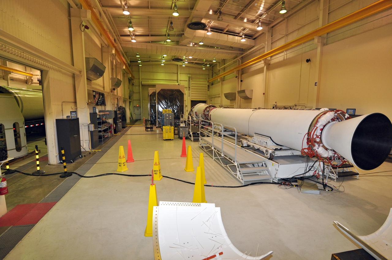 VANDENBERG AIR FORCE BASE, Calif. – The first, second and third stages of the Taurus XL rocket come together in the east high bay of Building 1555 at Vandenberg Air Force Base in California. In the west high bay, left, is the stage 0 motor. The rocket and NASA's Glory satellite are being prepared for a launch to low Earth orbit from Vandenberg's Space Launch Complex 576-E.      Once Glory reaches orbit, it will collect data on the properties of aerosols and black carbon. It also will help scientists understand how the sun's irradiance affects Earth's climate.  Photo credit: NASA/Randy Beaudoin, VAFB