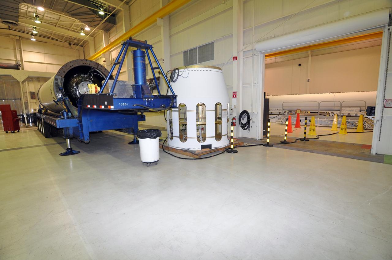 VANDENBERG AIR FORCE BASE, Calif. – The stage 0 motor, left, and the interstage associated with Stage 1 of the Taurus XL rocket are ready for more processing in the west high bay of Building 1555 at Vandenberg Air Force Base in California. In the east high bay, right, are the first, second and third stages. The rocket and NASA's Glory satellite are being prepared for a launch to low Earth orbit from Vandenberg's Space Launch Complex 576-E.    Once Glory reaches orbit, it will collect data on the properties of aerosols and black carbon. It also will help scientists understand how the sun's irradiance affects Earth's climate.  Photo credit: NASA/Randy Beaudoin, VAFB